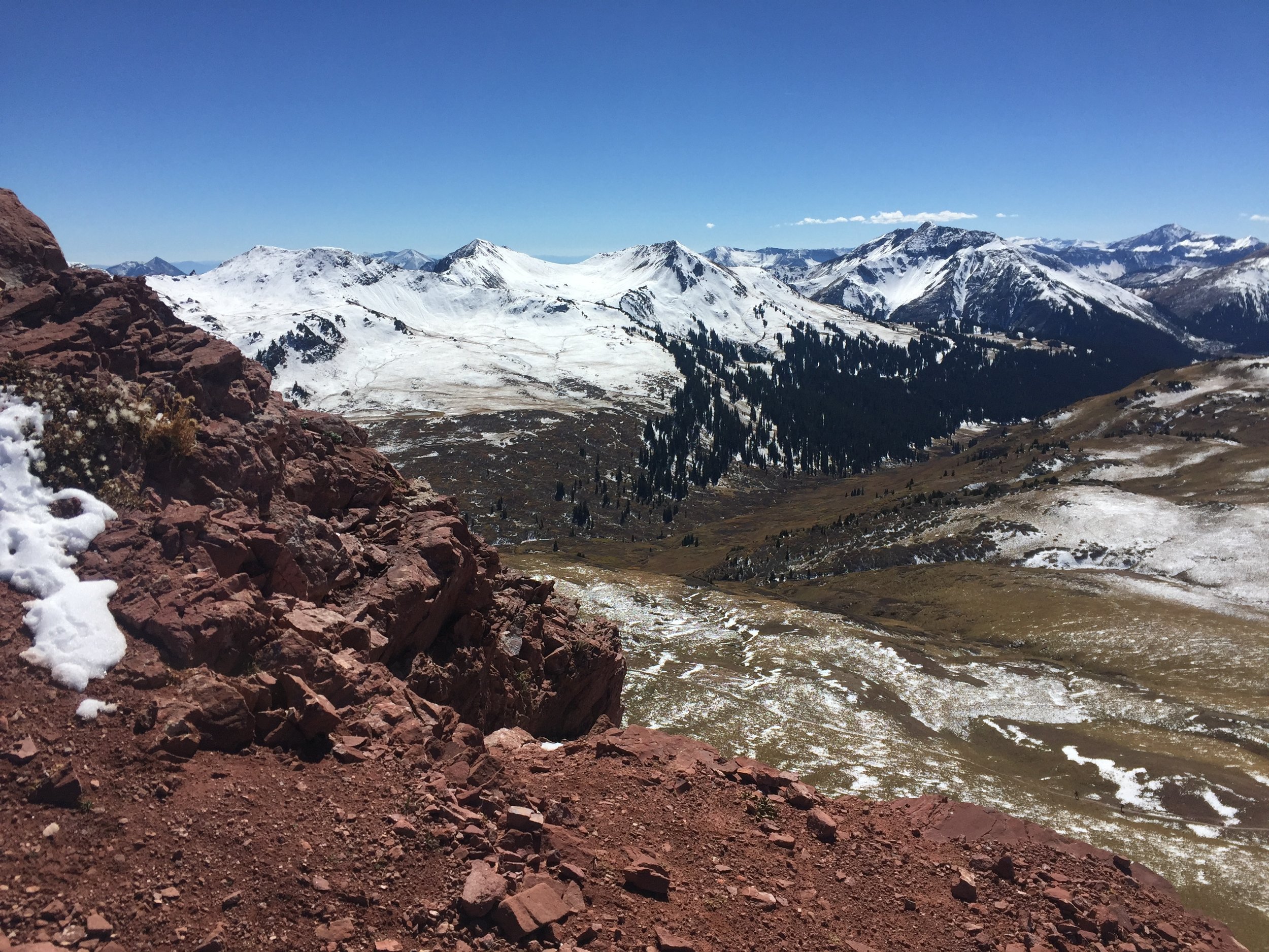 Basking in the sun on our third pass, Frigid Air (12,415ft), after battling up the hill through mud and snow.