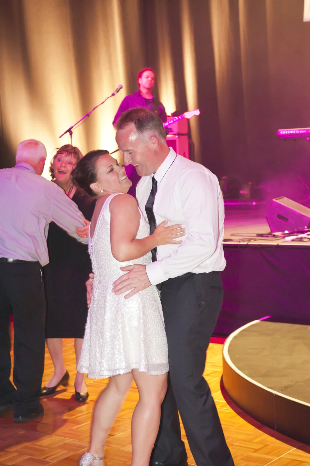 This image would have been captured at 1/60 however if the shutter speed was even lower (1/8 or 1/15) it would be better. It would show the movement of dance rather than freezing them. 