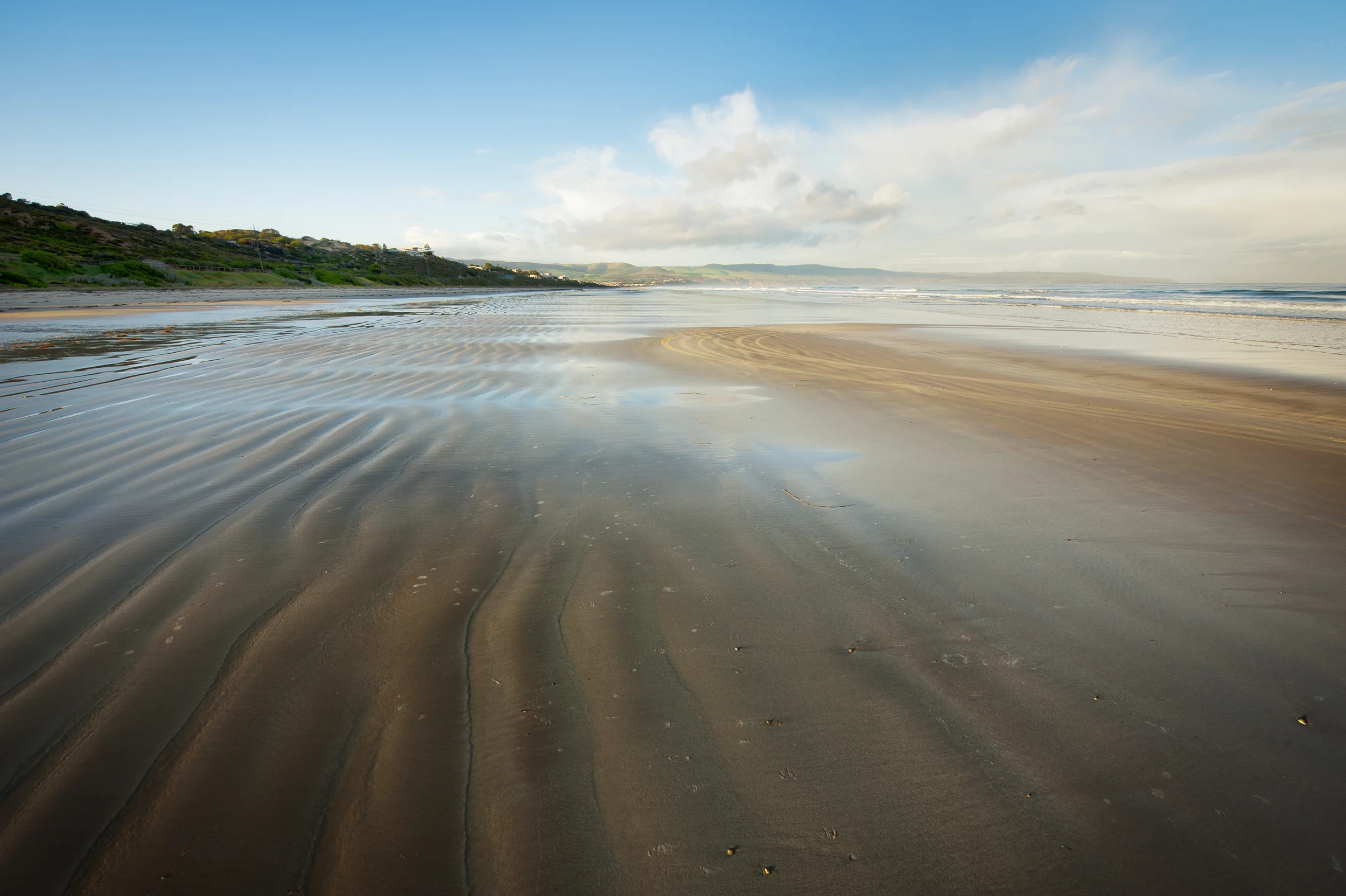 Lead in lines made naturally by the ocean in the sand. Draws the eye into the photo.