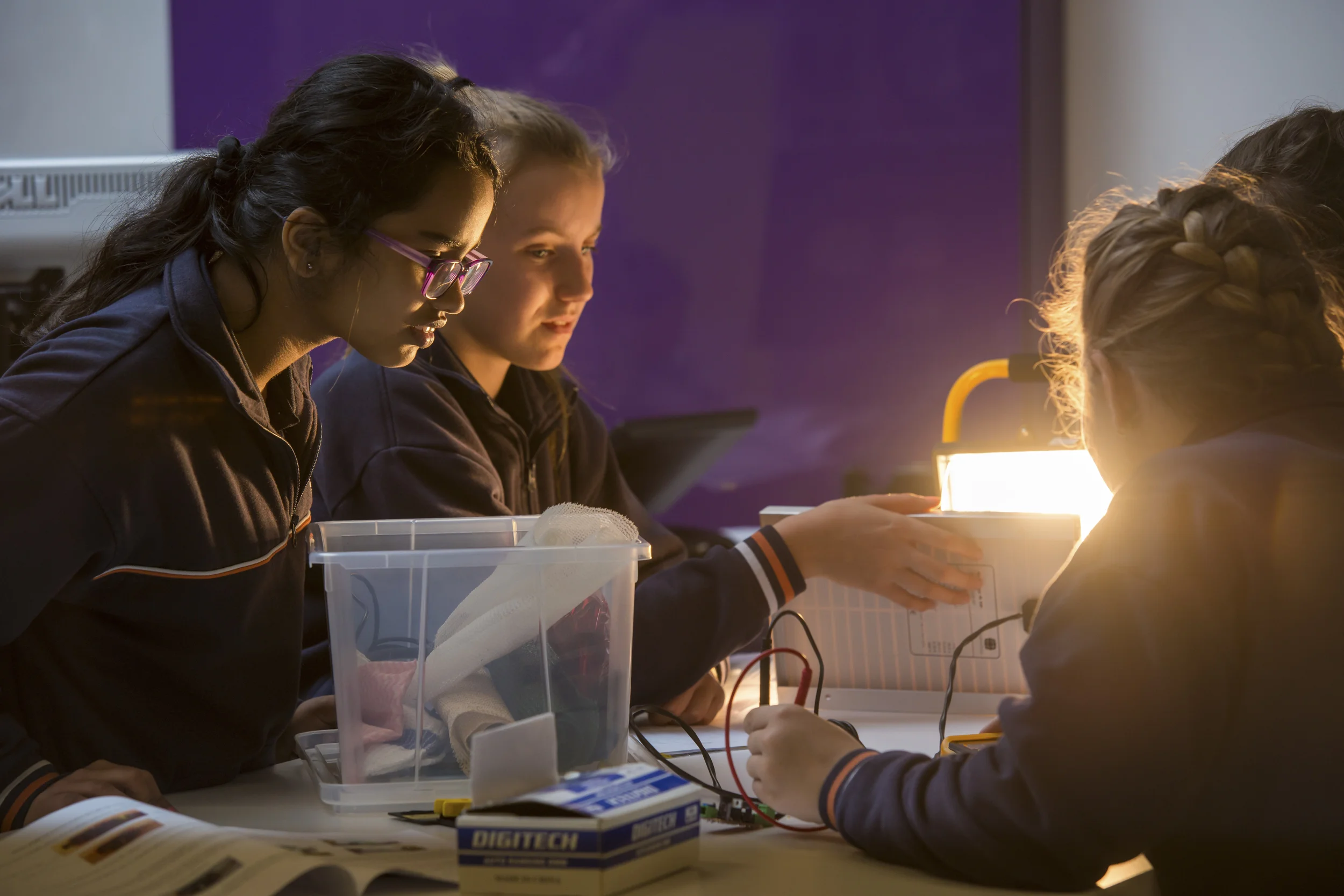 All attention on what they are doing. My eyes immediately go to where the light is, and particurarly the girls face of concentration.