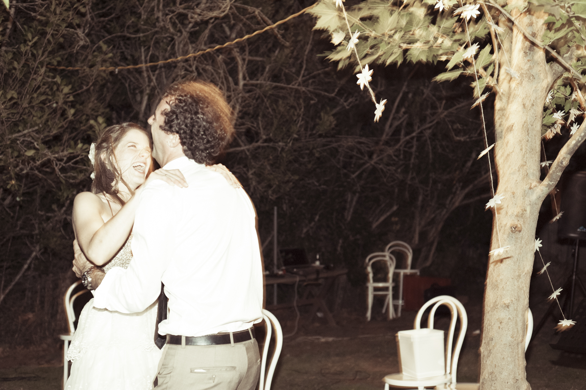 By slowing the shutter and using a flash, the couple retains some sharpness but the background has movement from the pan and slow shutter.