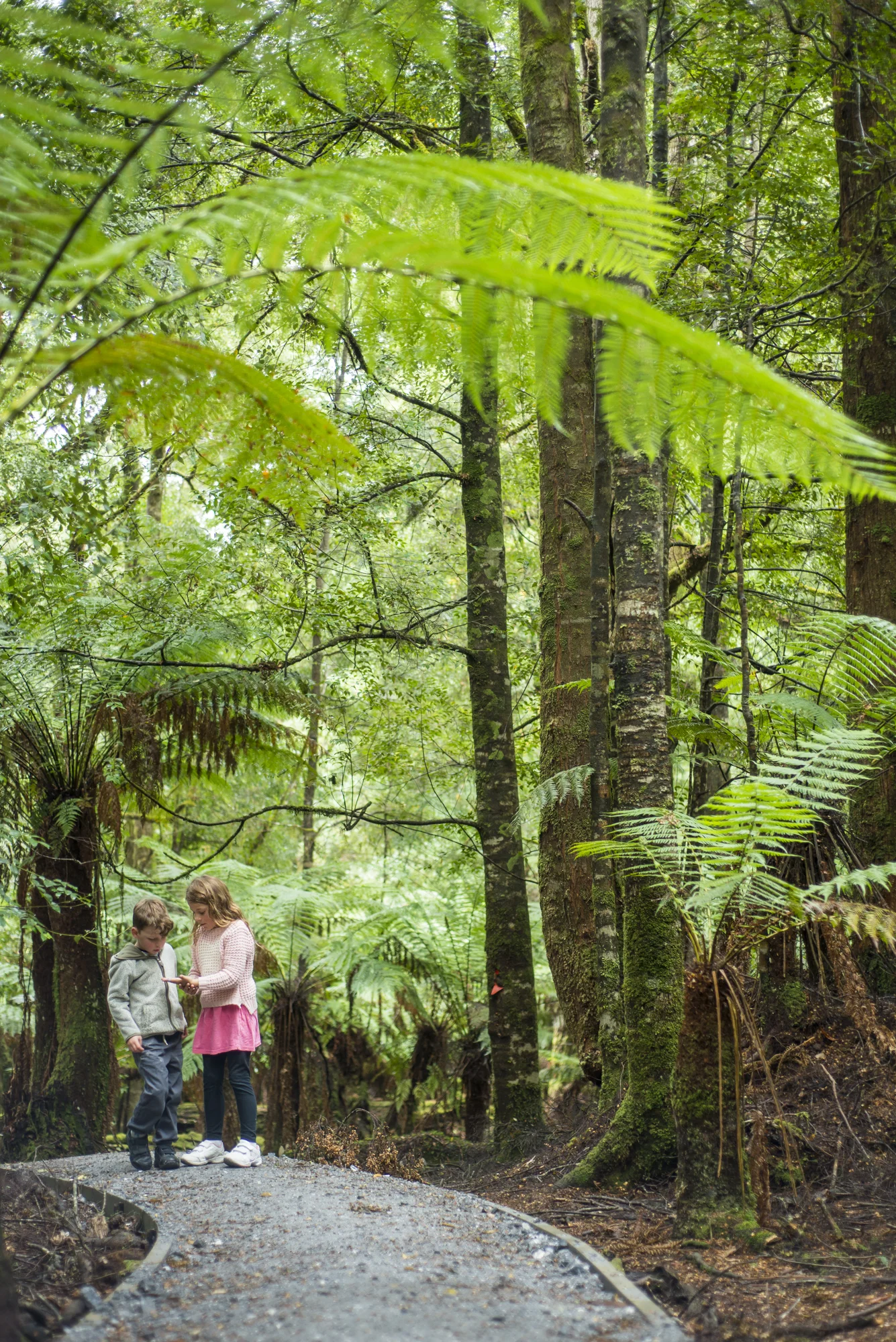 Belle and Ashton finding little bugs and leaves.