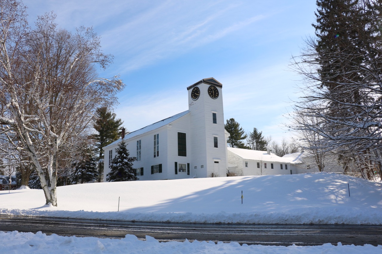 Fresh snowfall on the clean, empty lawn.