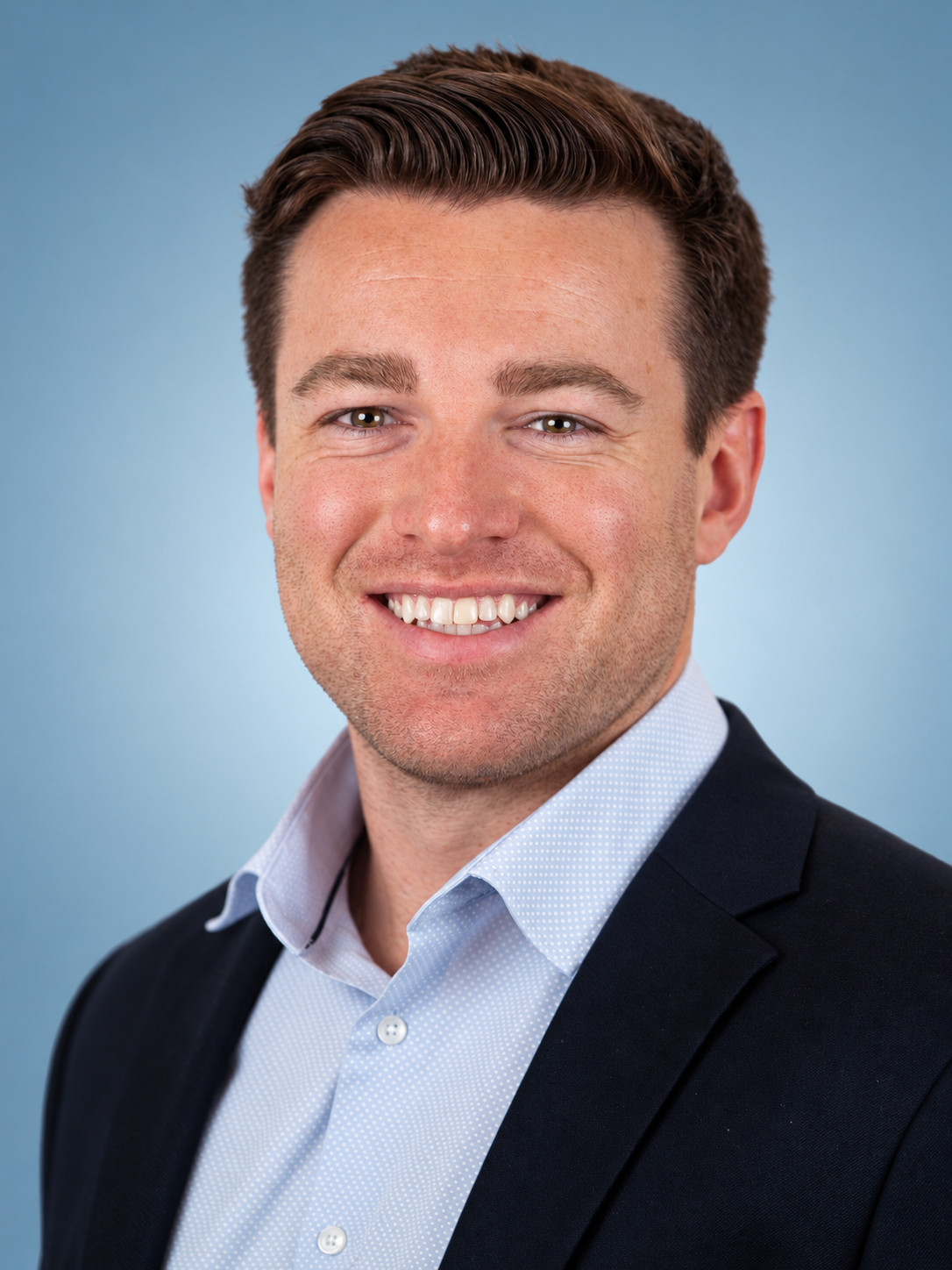 Professional Blue-Backdrop Corporate Headshot.png