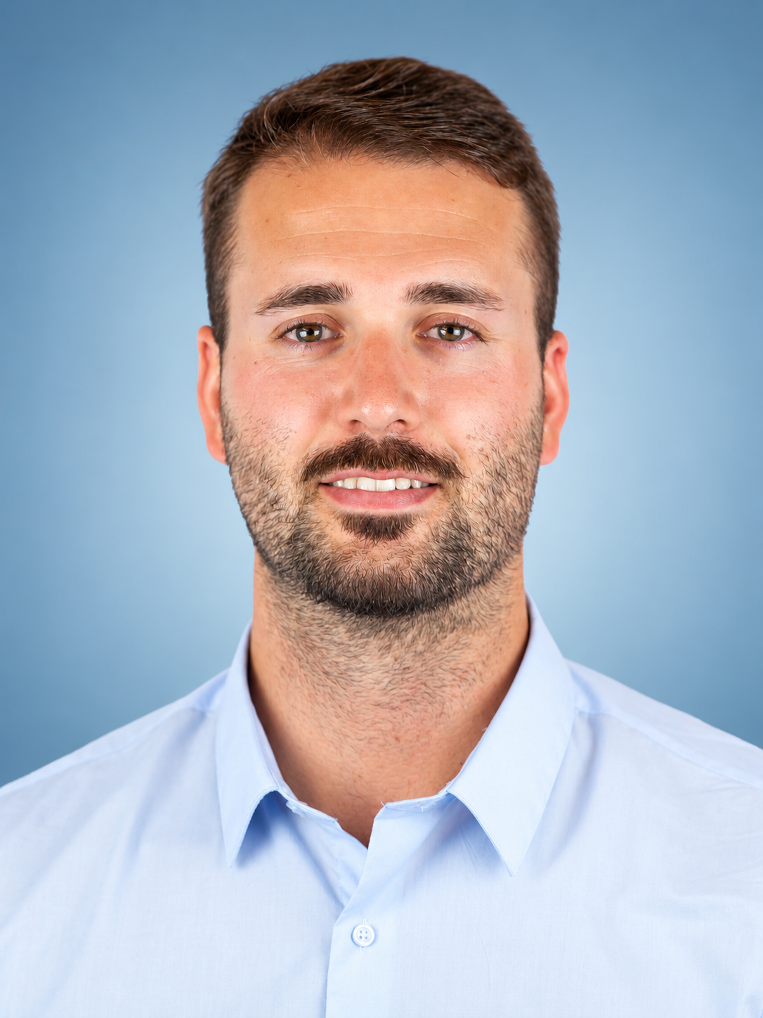 Professional Blue-Background Headshot.png