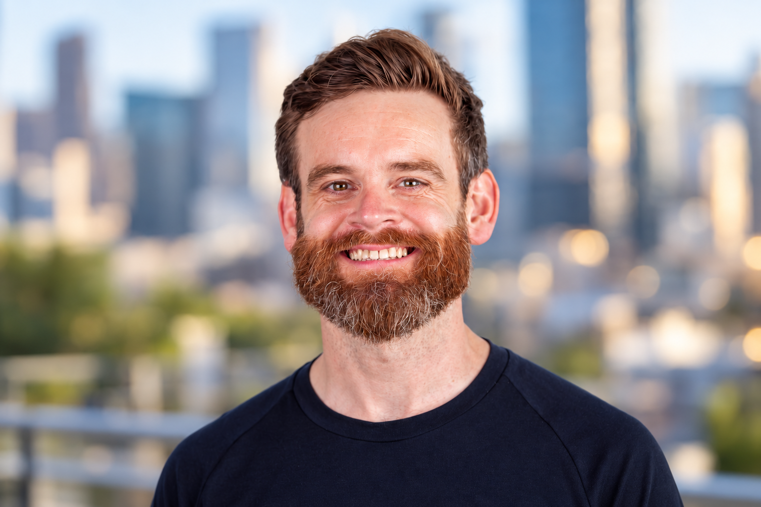Smiling Bearded Man in City Bokeh.png