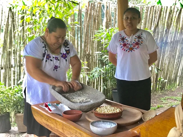 Hand-grinding the corn for the tortilla-making lesson