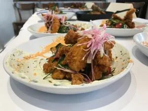 Maggie Cellitto of Matt’s Fish Camp in Bethany Beach placed fried chicken on a crispy chicken skin tostada.