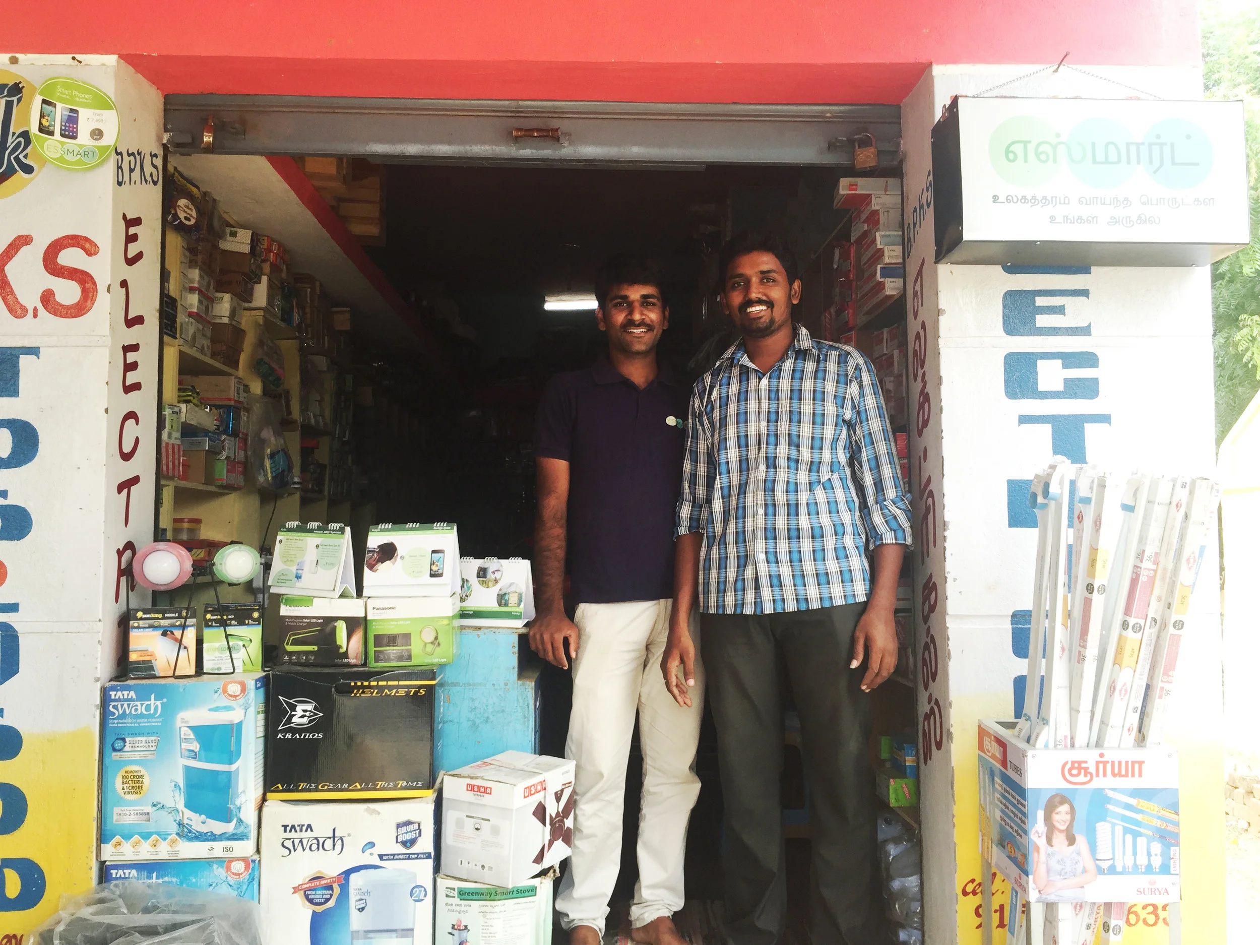 Shop owner with Essmart Sales Executives displaying Essmart products_edited.jpg