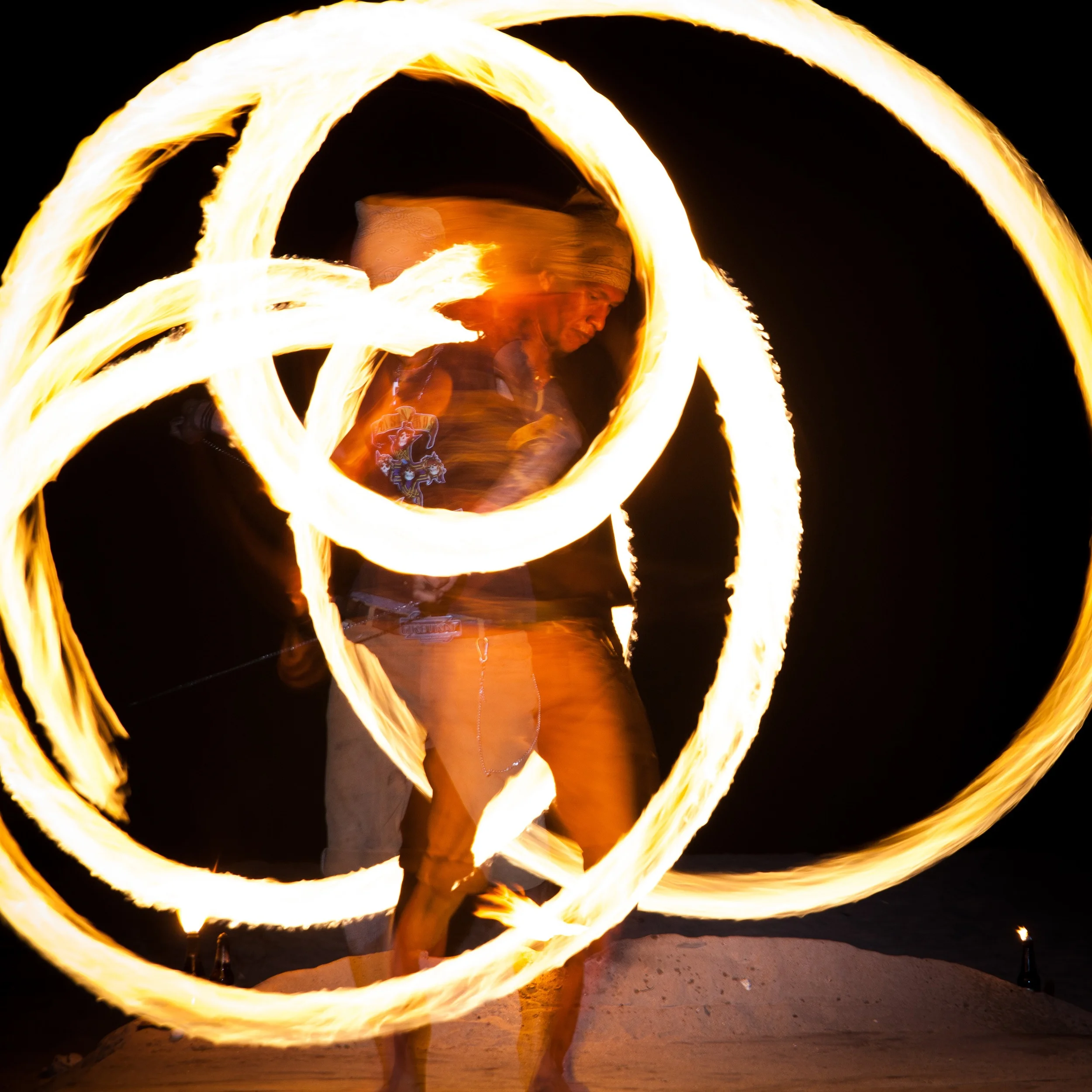 A long exposure and an off camera flash can freeze a subject for a moment while still capturing motion. This guy had some real skill.