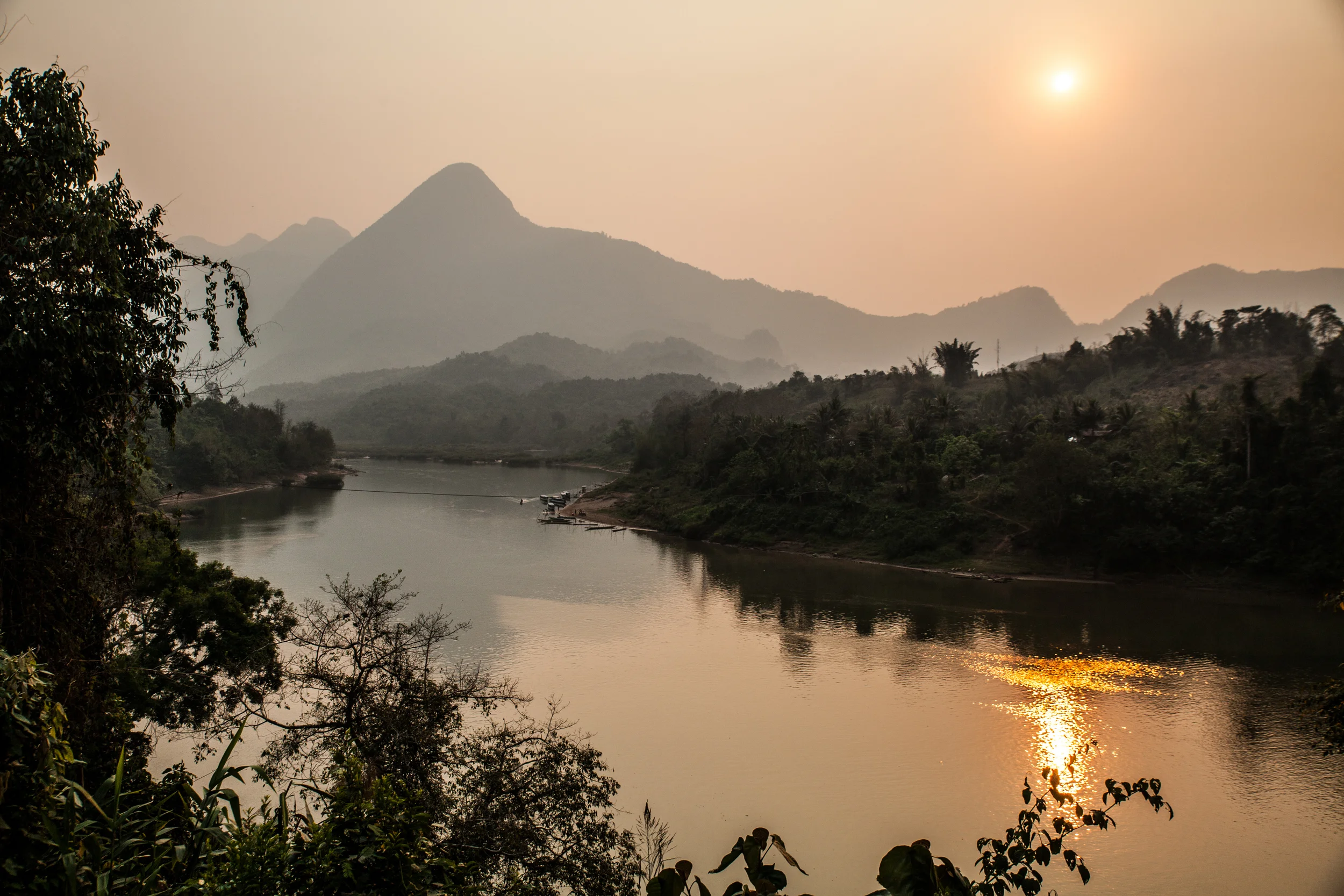 The Nam Ou River and a hazy sunset. 