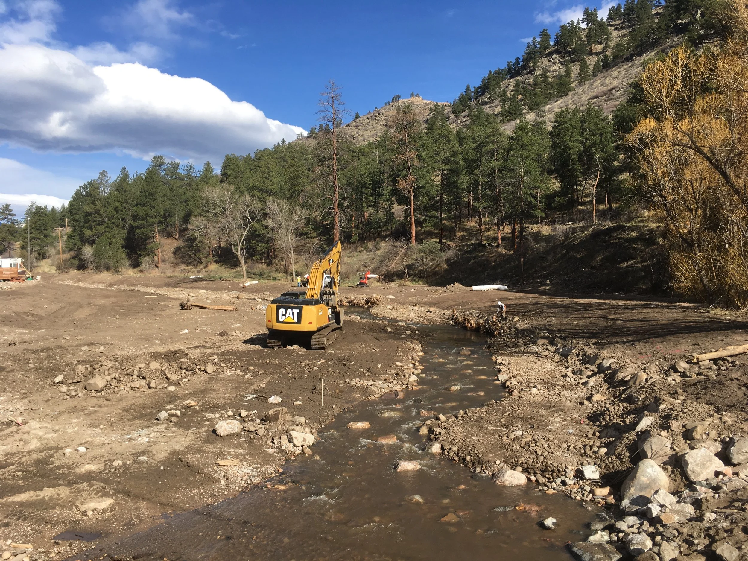 March 2017: Looking upstream at the North Fork from the US 34 bridge during construction. The project removed sediment and debris to increase the river corridor’s size and allow areas for future sediment deposition and realigned the channel for improved floodplain access and a better approach to the bridge. Wood and rock structures are intended to provide bank protection and grade control while allowing for natural shifting of the low-flow channel.