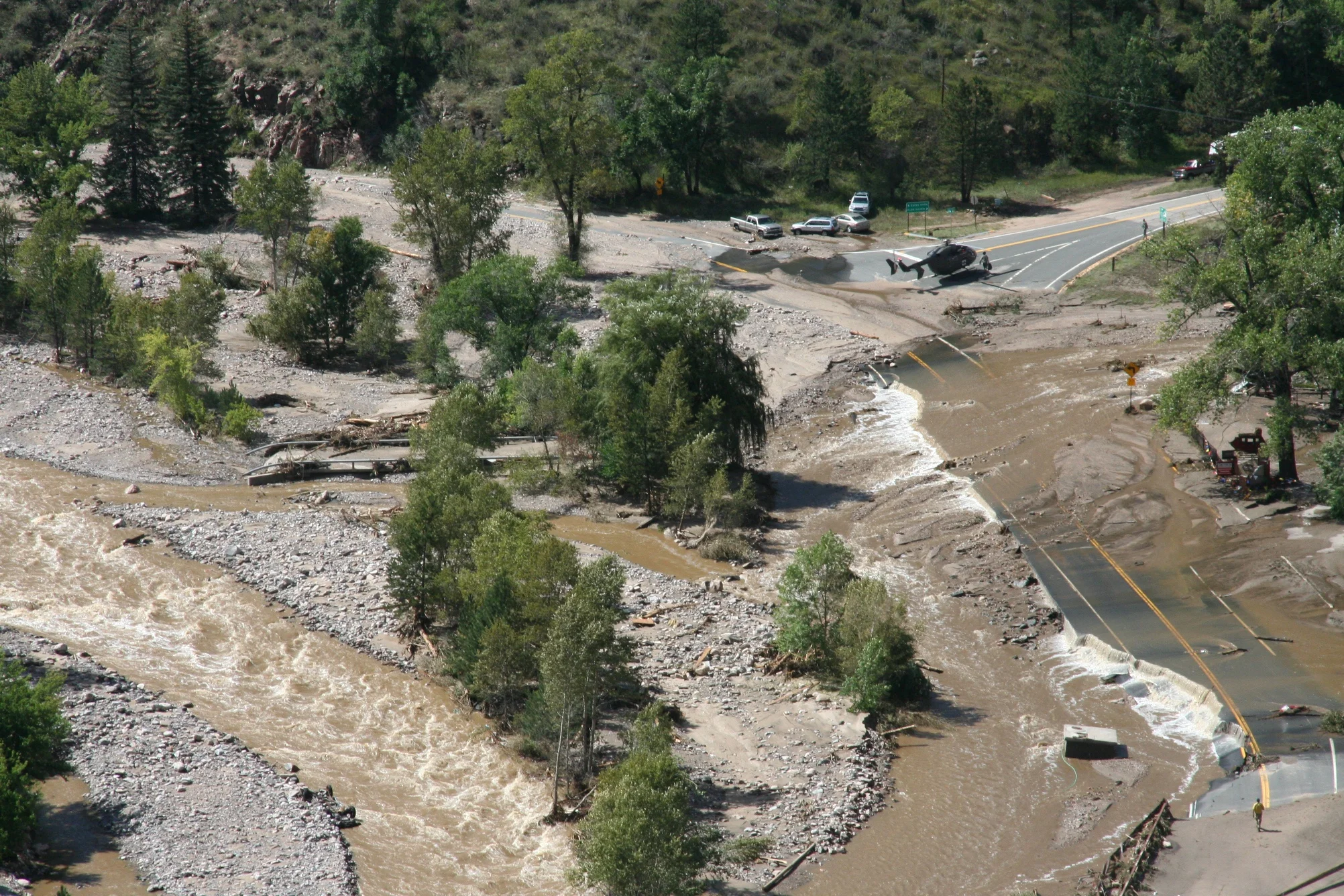 Above: Drake, Colorado. The Big Thompson River re-occupied the entirety of the Active River Corridor during the 2013 flood, flanking bridges and depositing sediment eroded from upstream reaches and captured during hillslope failures triggered by river movement. Photo: Civil Air Patrol.