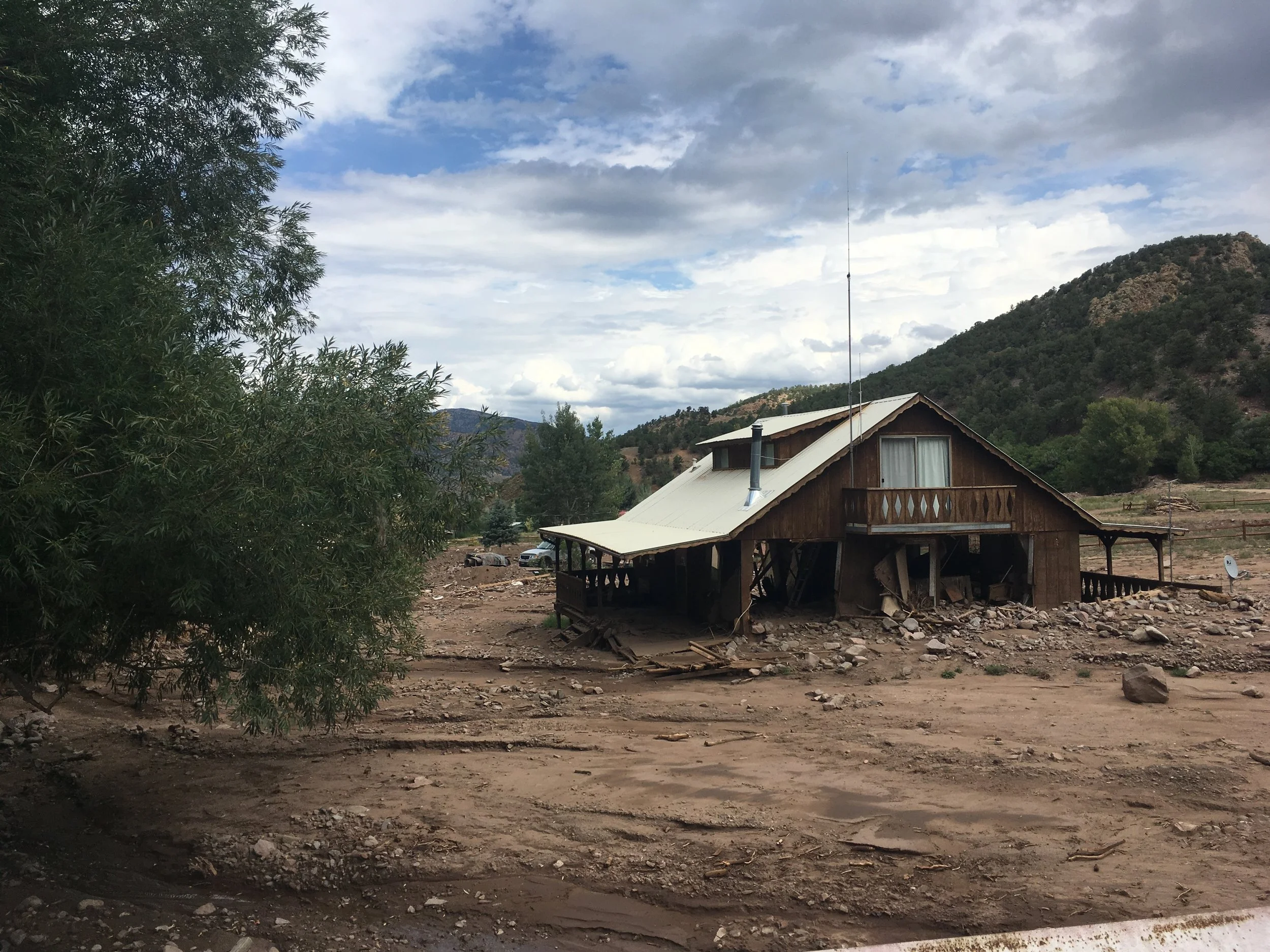 A home near Cotopaxi, Colorado destroyed by water and sediment moving over an alluvial fan. This damage was not associated with a dramatic flood event, rather it was the result of a typical summer thunderstorm that occured over an area burned by a wildfire.