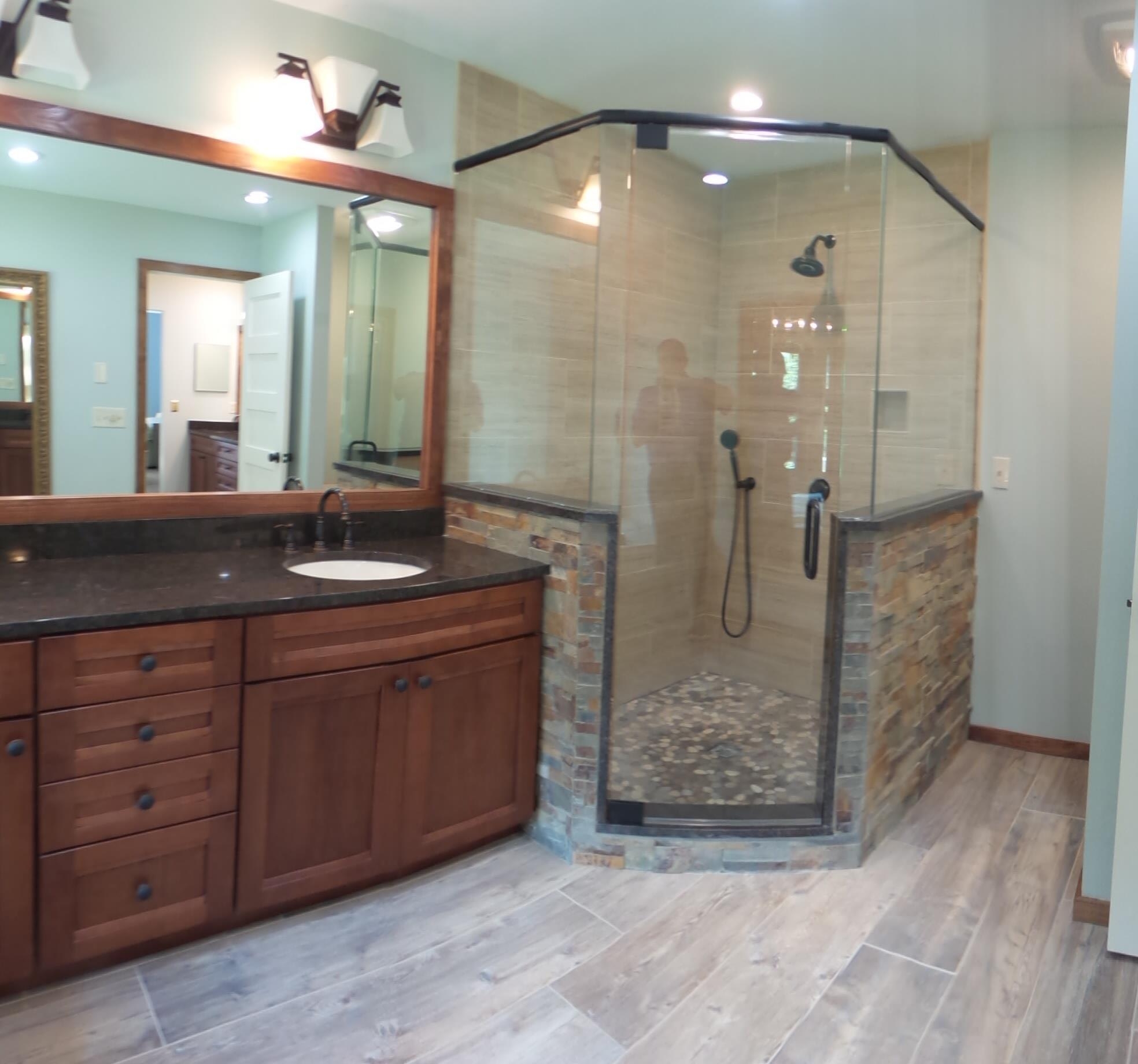 Custom shower with On/Off mixer valve concealed on half wall as you enter so you can turn on and not get wet while waiting for the water to warm up.