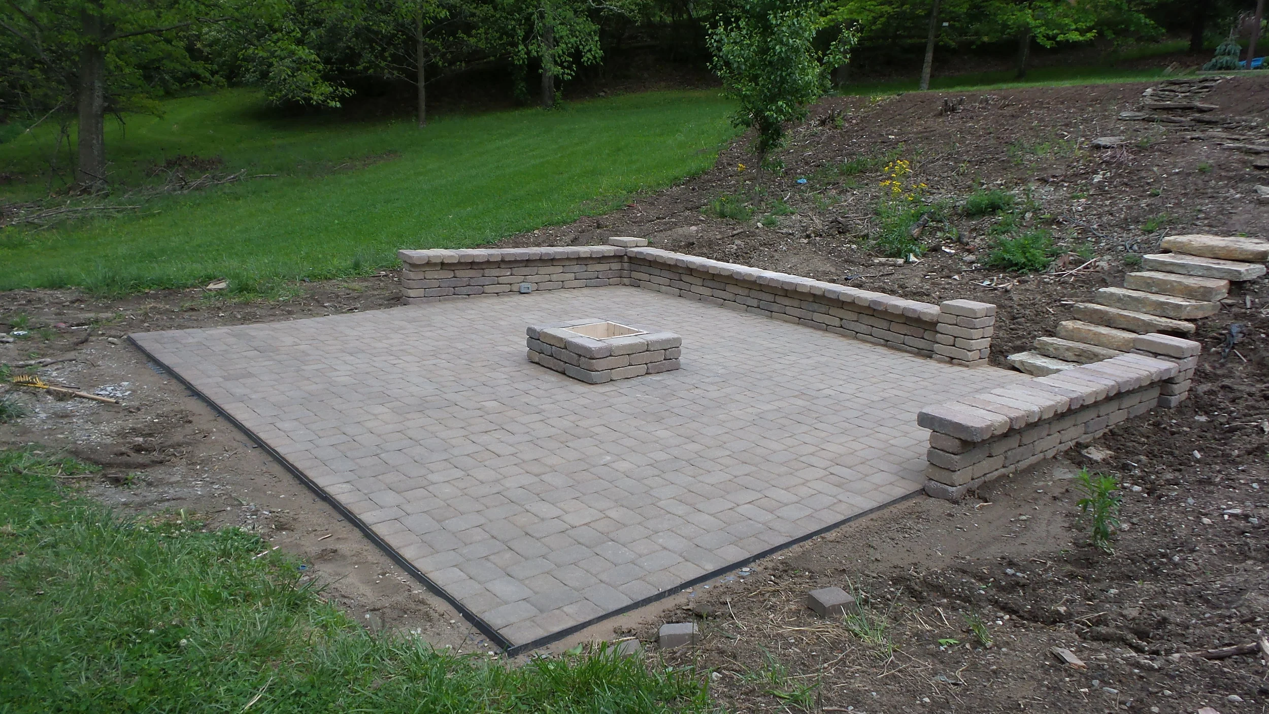 Paver patio with fire pit and stone step walkway