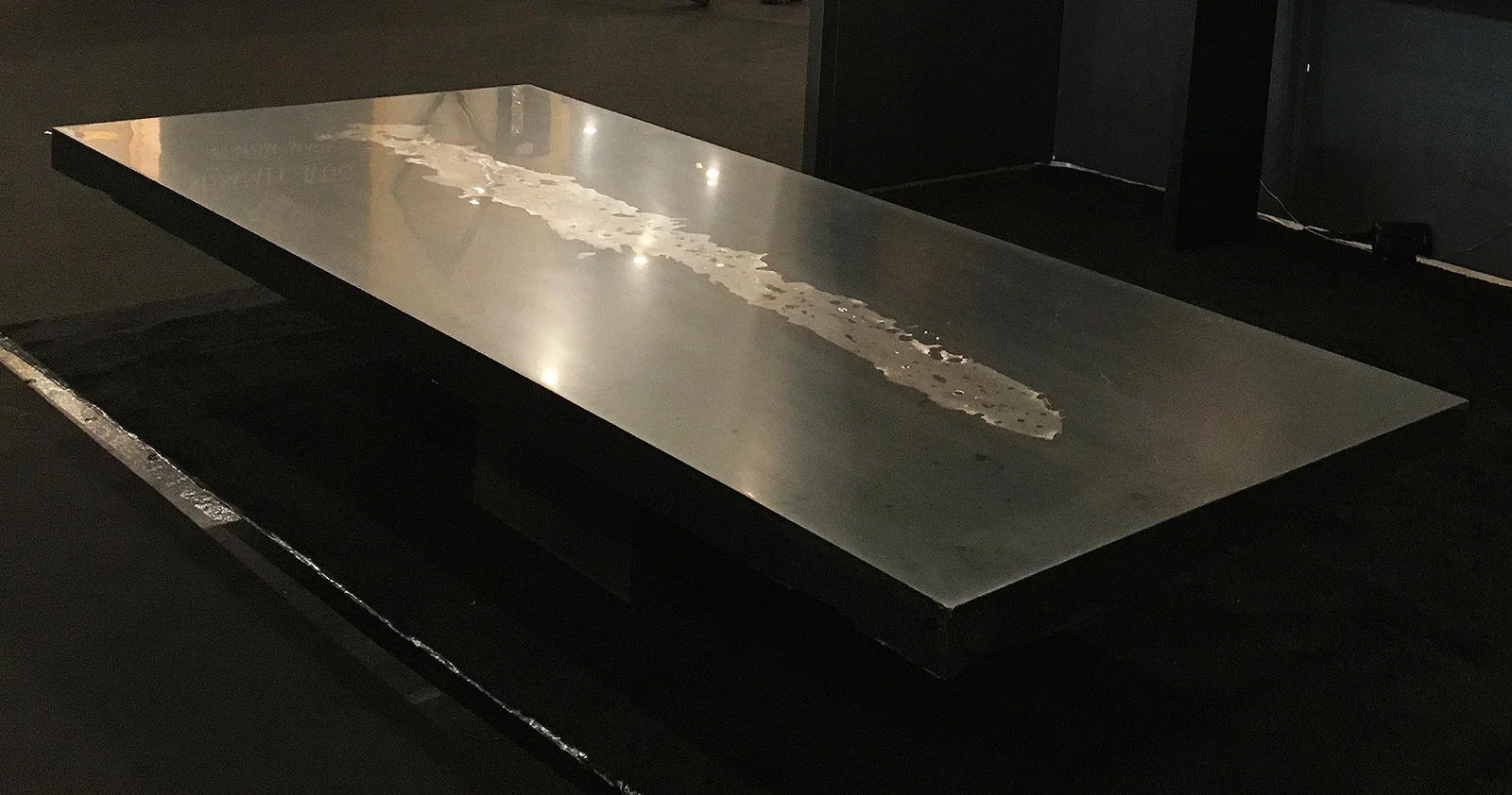 ether_atelier_thrown_molten_metal_graphite_table.jpg