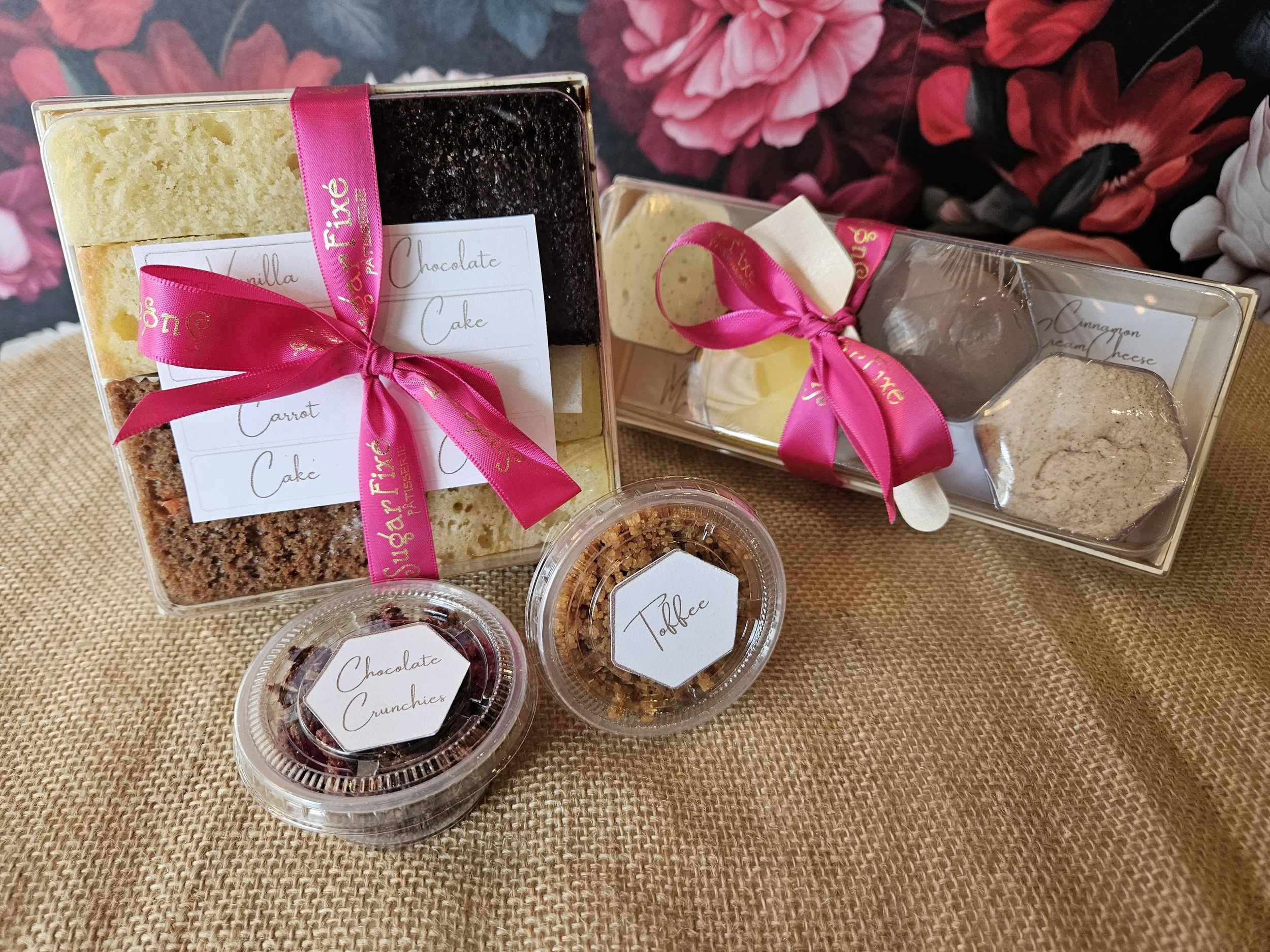 Cake tasting kit with a pink-ribboned box, sample cups of frosting and a tray of cake slices