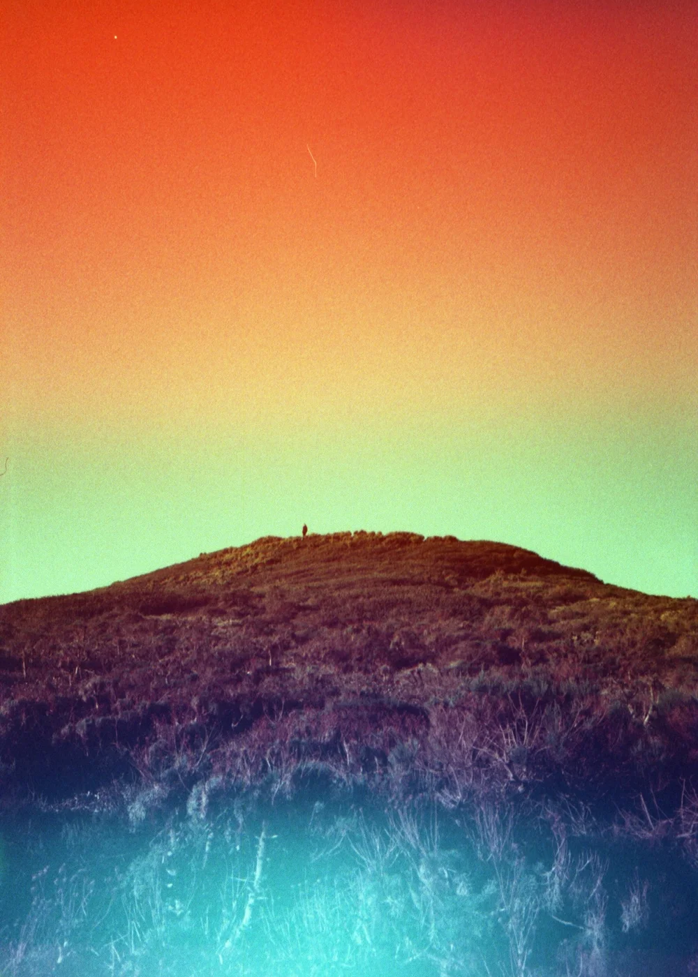 Psych Blues #8 pre-exposed 35mm experimental film photo of a hill with colorful light leaks