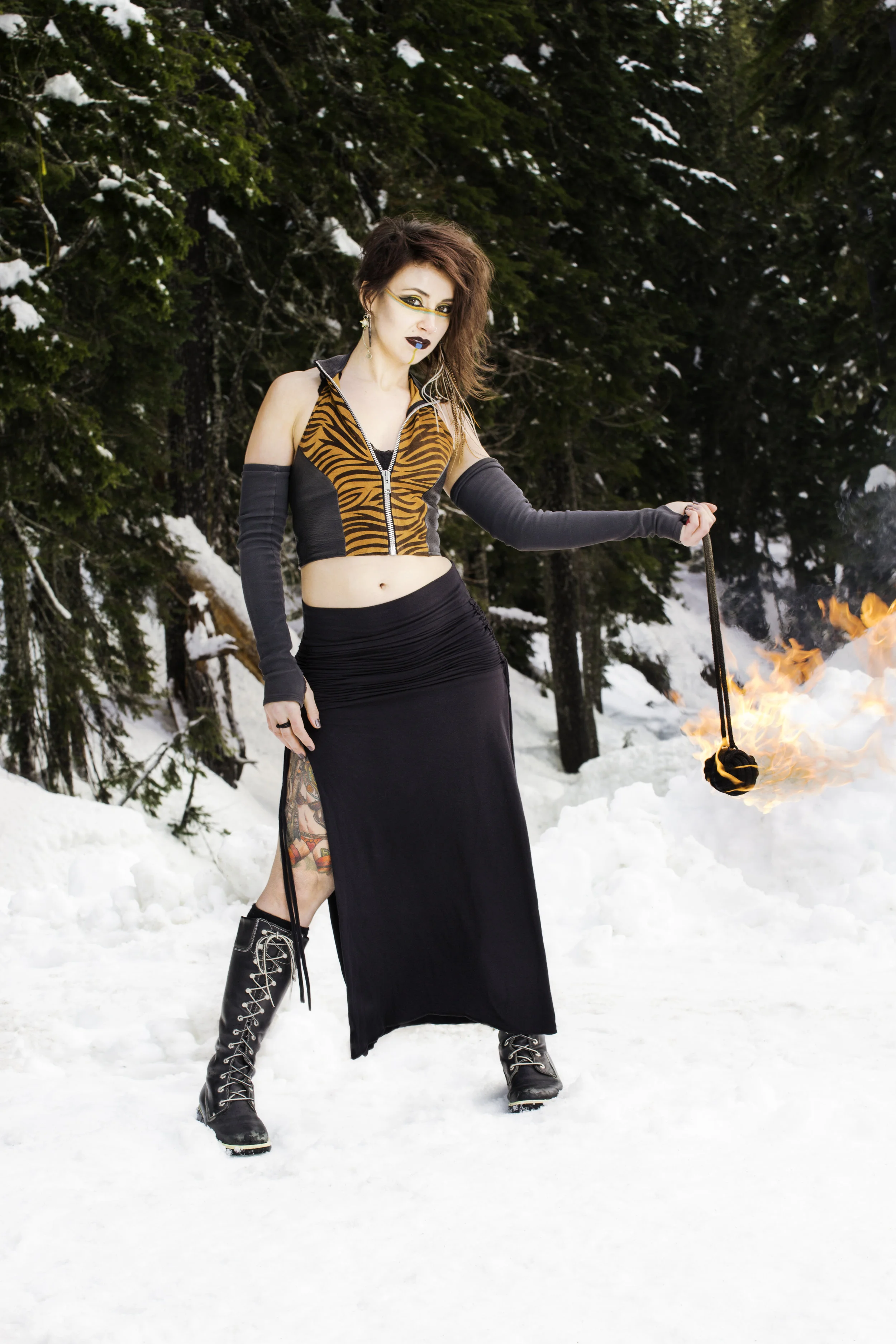 Fashion photograph of a fire dancer in the snow.