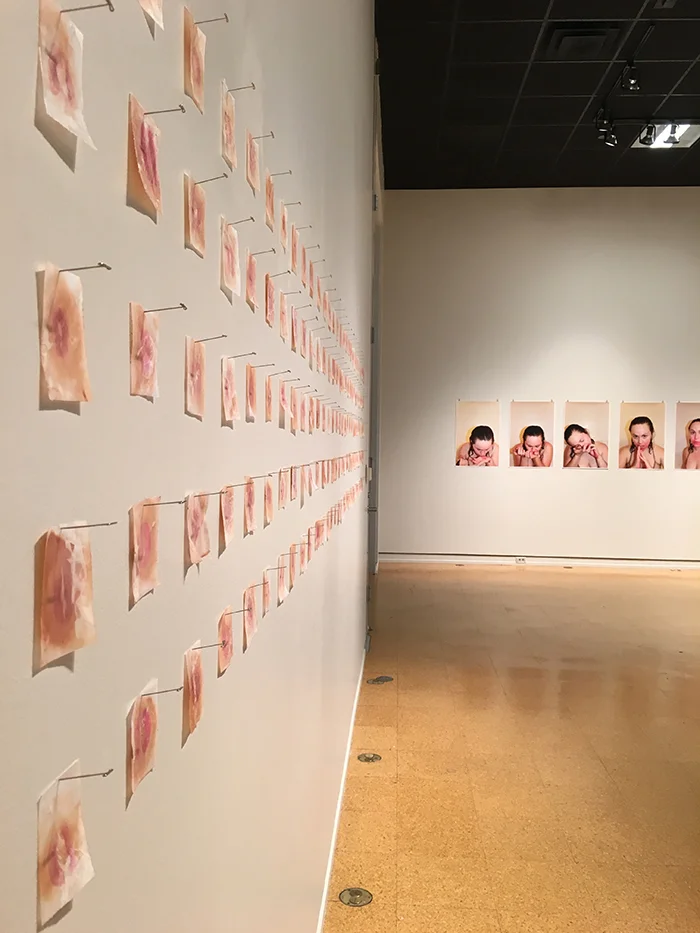 hers/his , 2016. Lipstick, oil, & wax on velum. Install view from Solo mía at Southwestern University in 2016. 