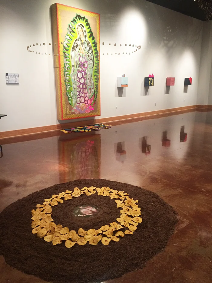 Para mamár de ella, hay que amarla a ella , 2015. Photography, corn masa, hominy, potting soil & nylon. Installation view of De la tierra , curated by Michael Anthony Garcia at Texas State University. 
