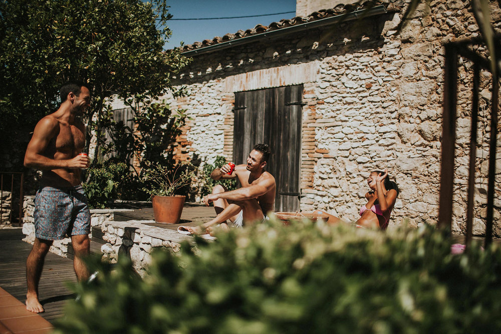  wedding guest enjoying a beer by swimming pool in casa felix olivella barcelona spain 