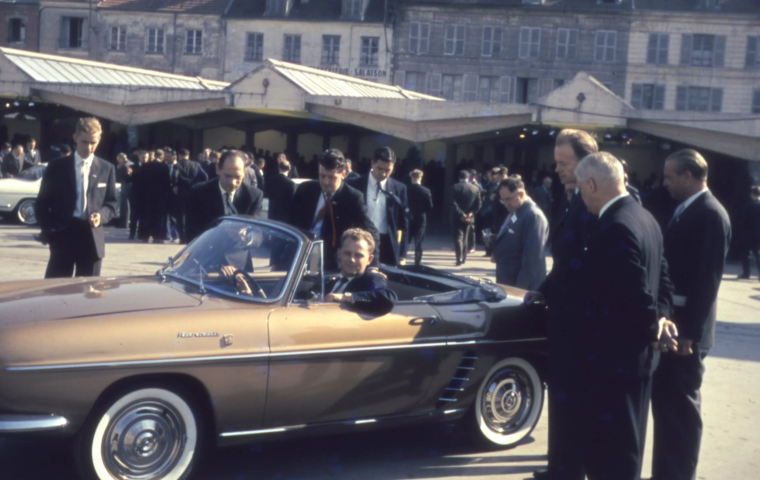 De danske Renault-forhandlere var i 1959 inviteret til Renault-fabrikkerne og til lancering af de to nye modeller, Stafette og Floride. Adm. direktør Pierre Dreyfus havde under besøget inviteret den danske stab til middag. Her ses nogle af de danske forhandlere i fuld gang med at inspicere den nye Floride for første gang. Billedet blev taget af Palle Saust fra Frisia i Vognmagergade i København. 