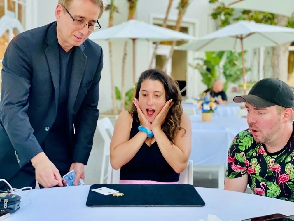 Corporate magician Lou Serrano performing interactive magic during a corporate dinner event