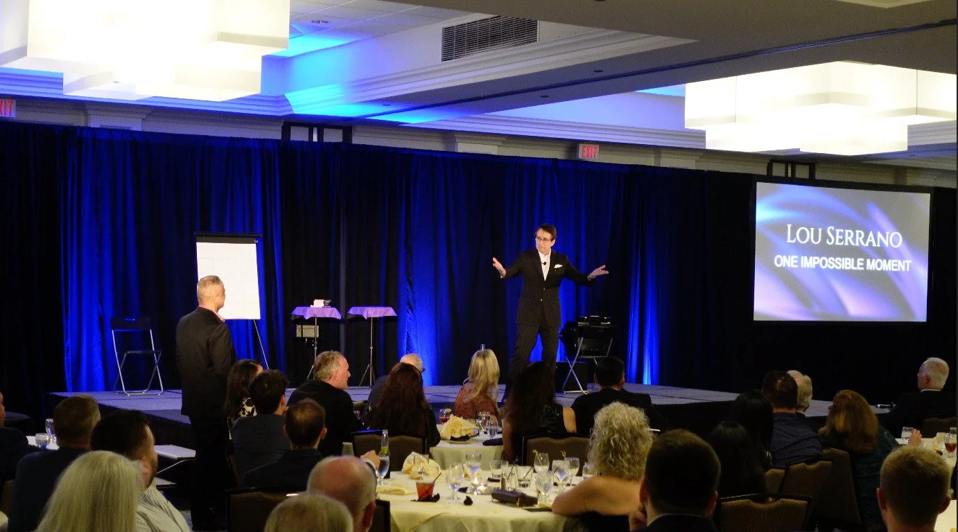 Lou Serrano the mentalist on stage at a corporate conference.