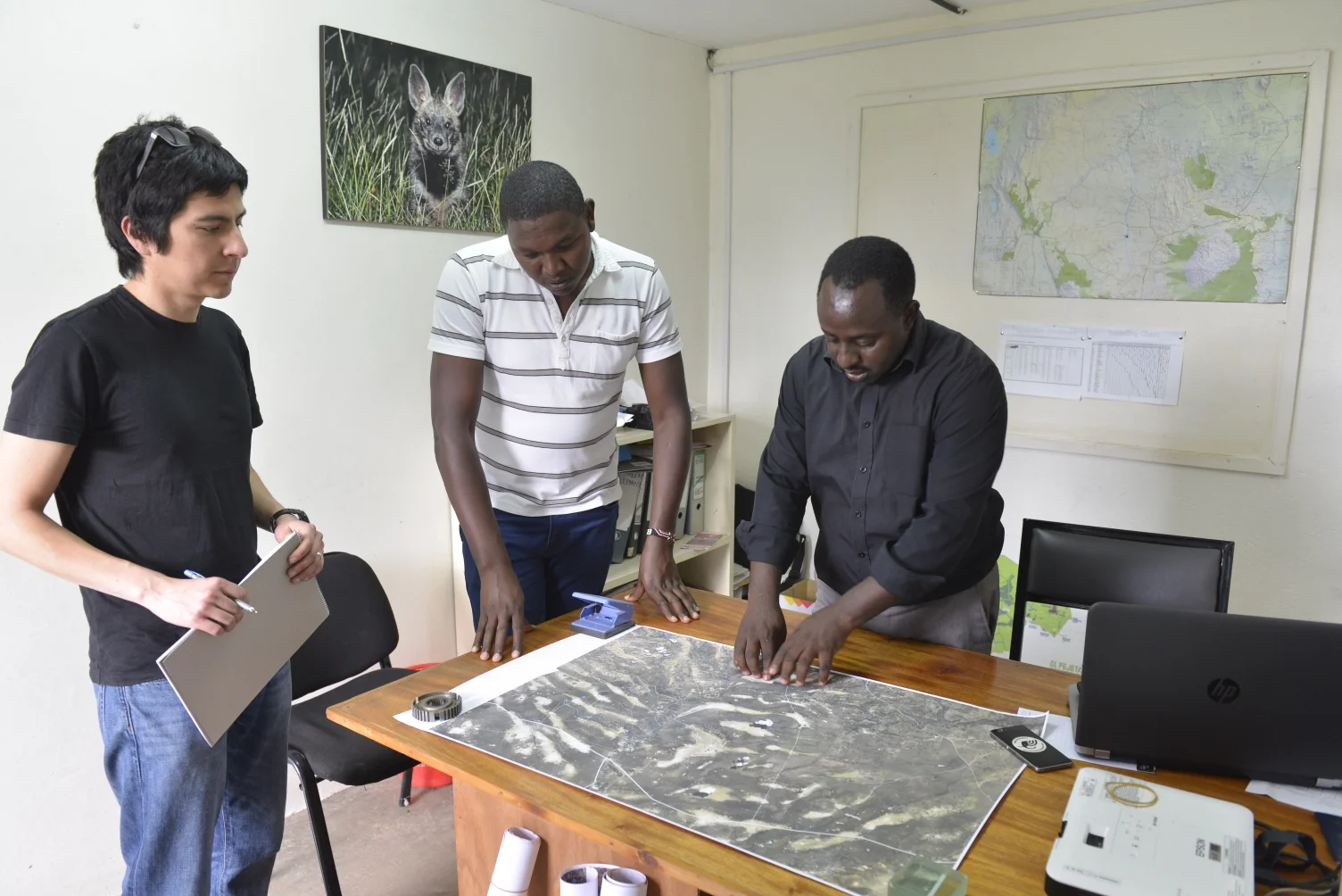 Bernard (centre) and Samuel (right) pointing out the different vegetation types at Ol Pejeta visible in the satellite image