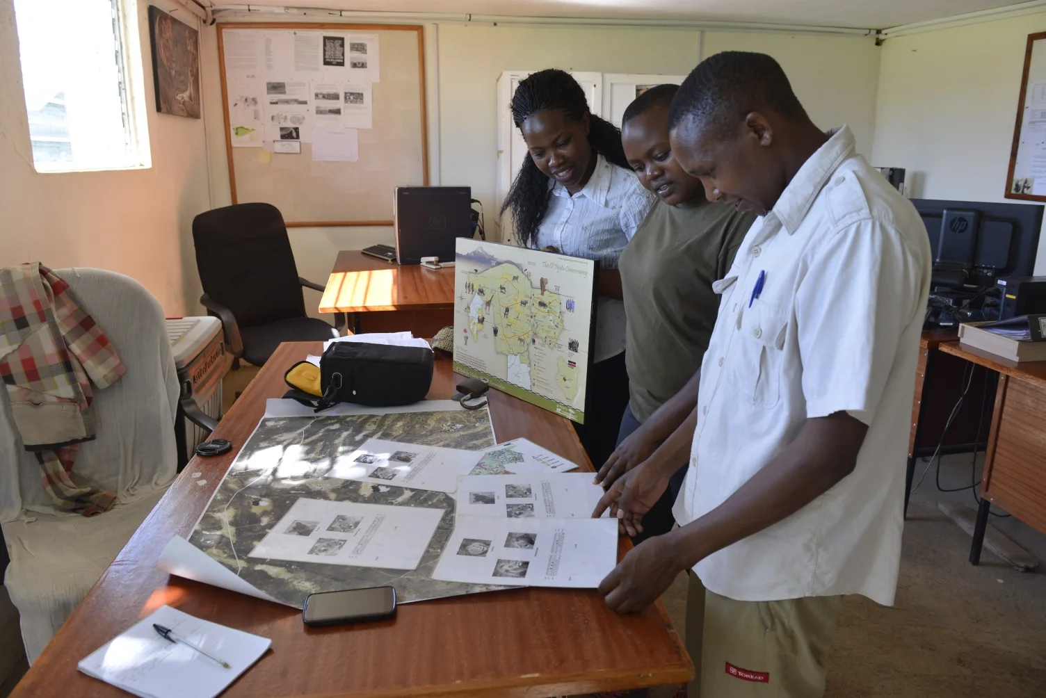 Chris (right) explains how lions are identified by their whisker patterns, and where the prides are located
