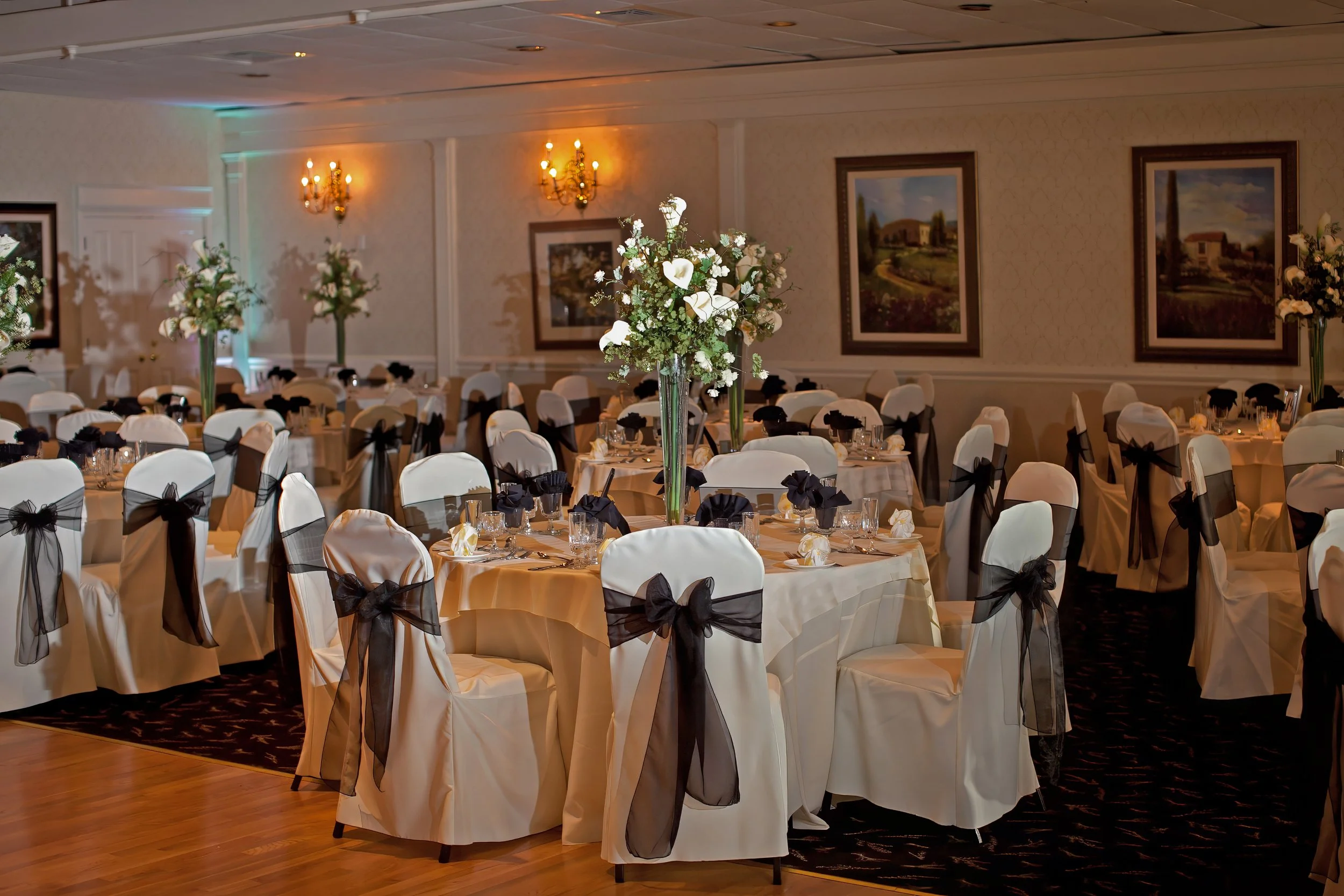 Tall floral centerpieces in ballroom at Amarante’s Sea Cliff wedding reception