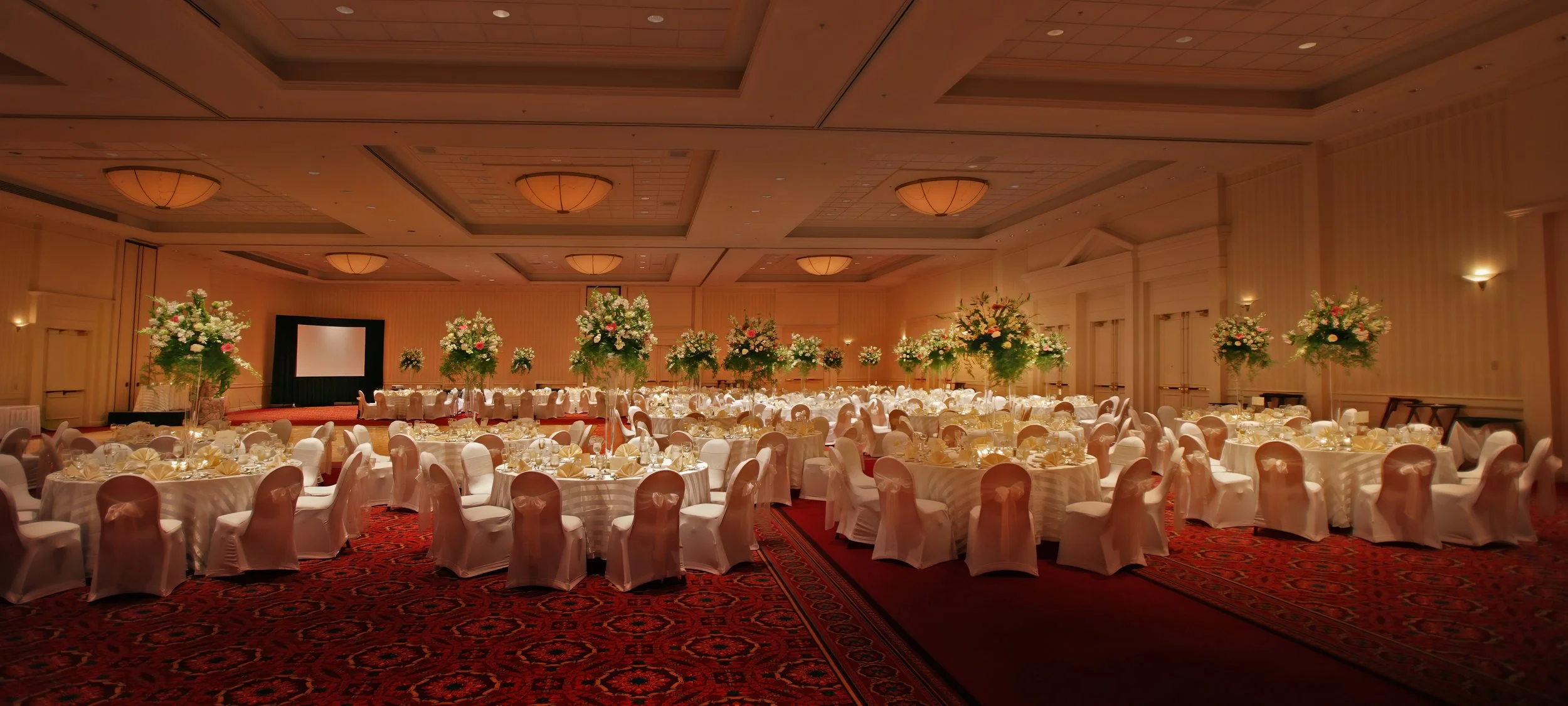 Sweeping view of wedding reception décor inside the Mystic Marriott Ballroom in Groton Connecticut.
