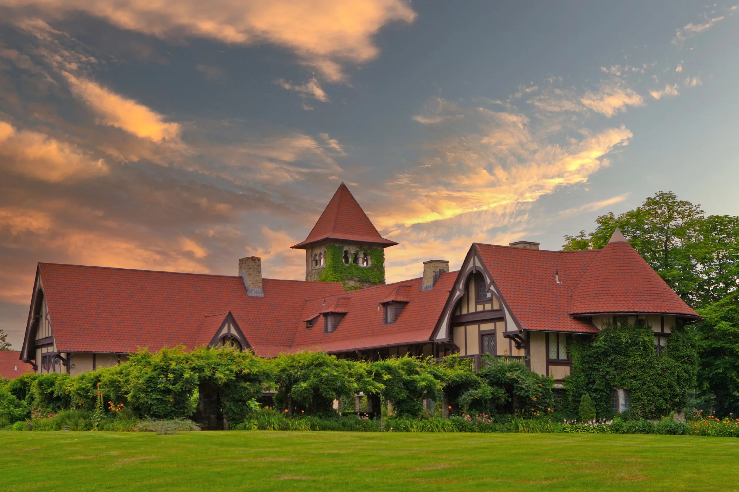 Exterior view of Saint Clements Castle in spring with gardens and trees in bloom