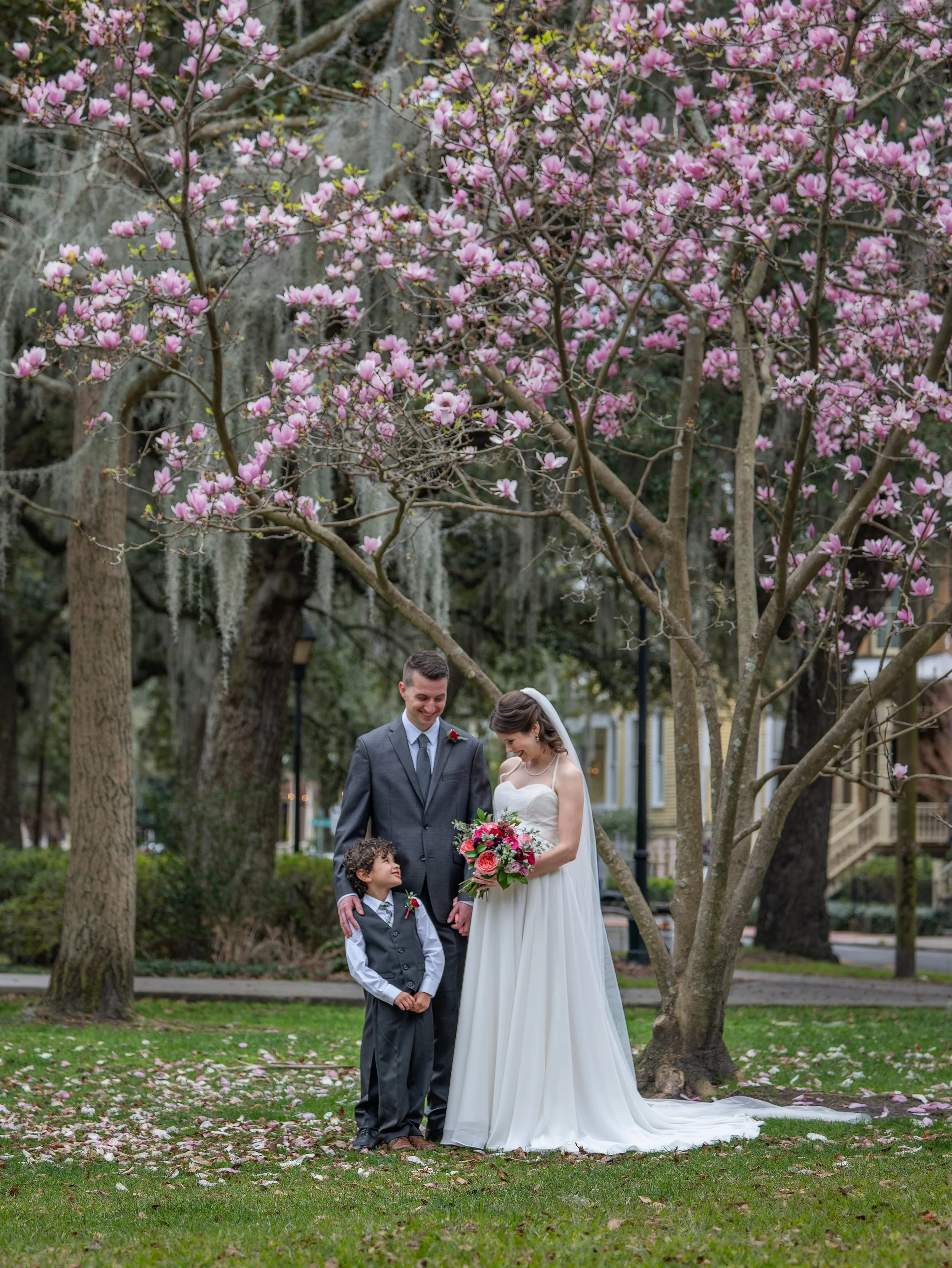 Tim and Daniella pose with their child and immediate family following their intimate wedding ceremony in Forsyth Park.