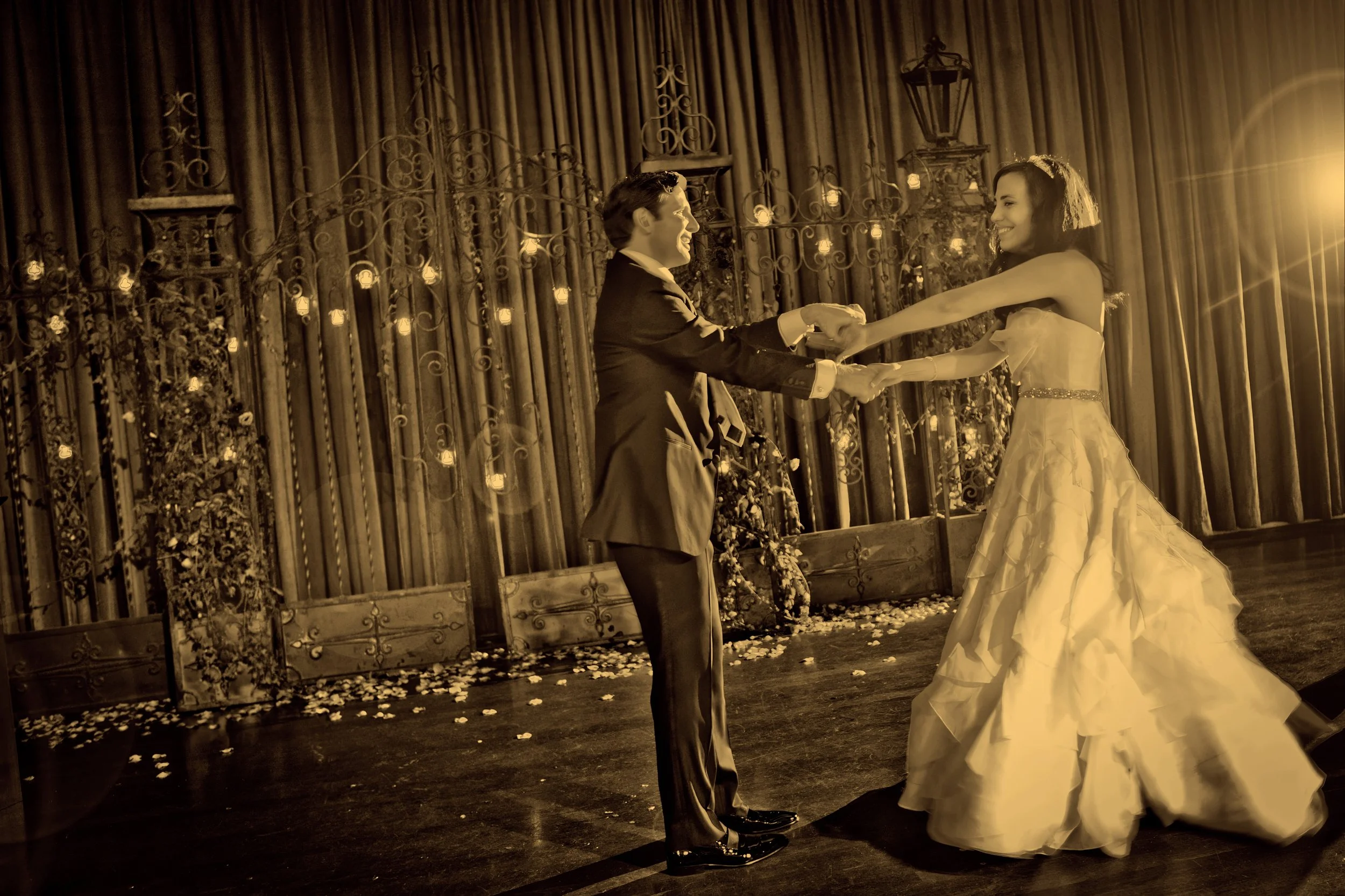 Bride and groom sharing their first dance together as husband and wife in an elegant fine art photograph.