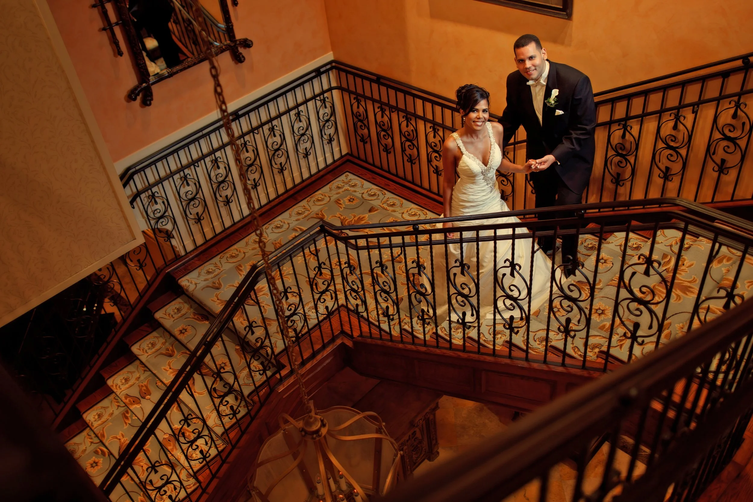 Portrait of bride and groom together on the grand staircase at Delamar Greenwich Harbor.