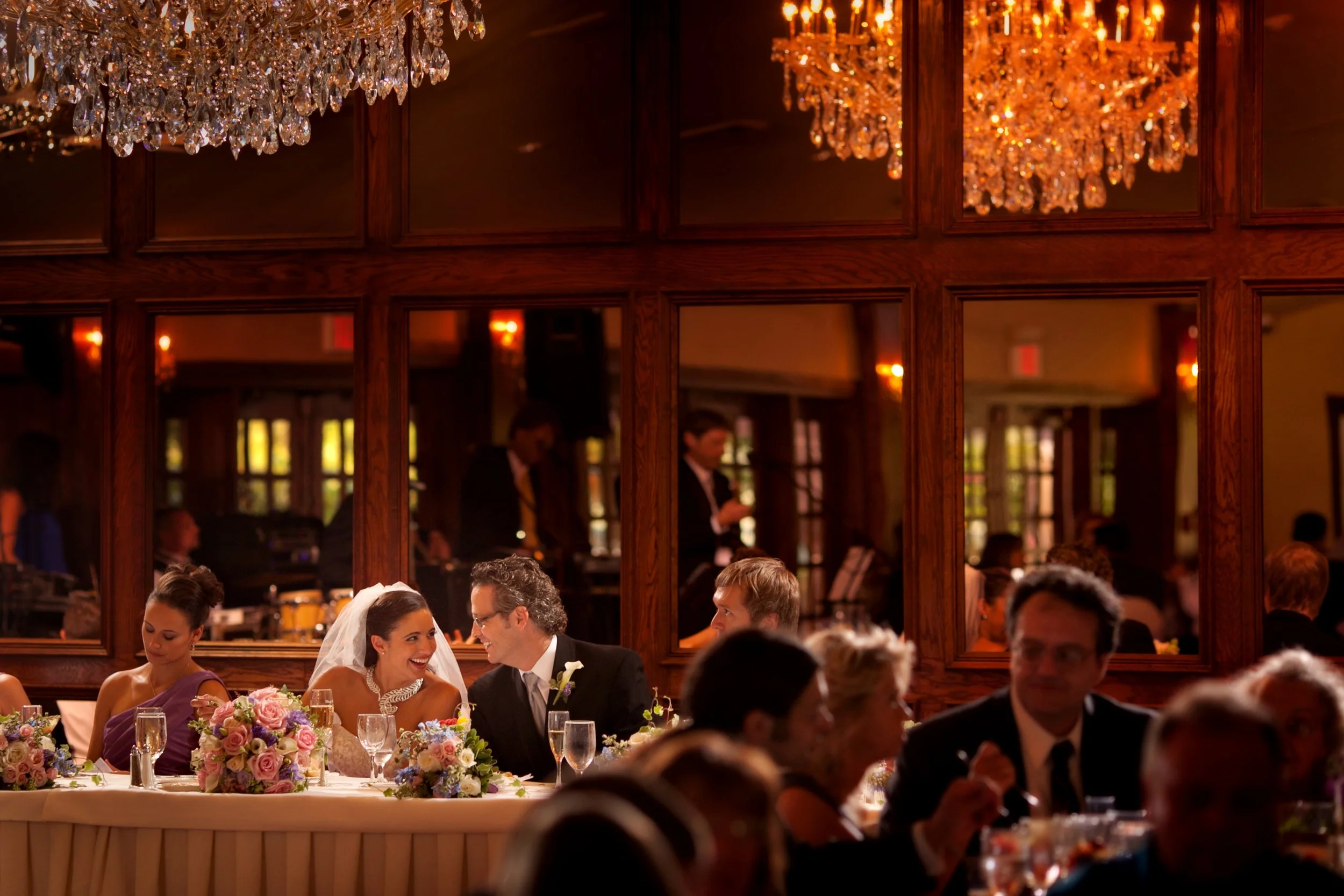 Bride and groom enjoy an intimate dinner in the Waterford Ballroom at Saint Clements Castle, captured from afar.