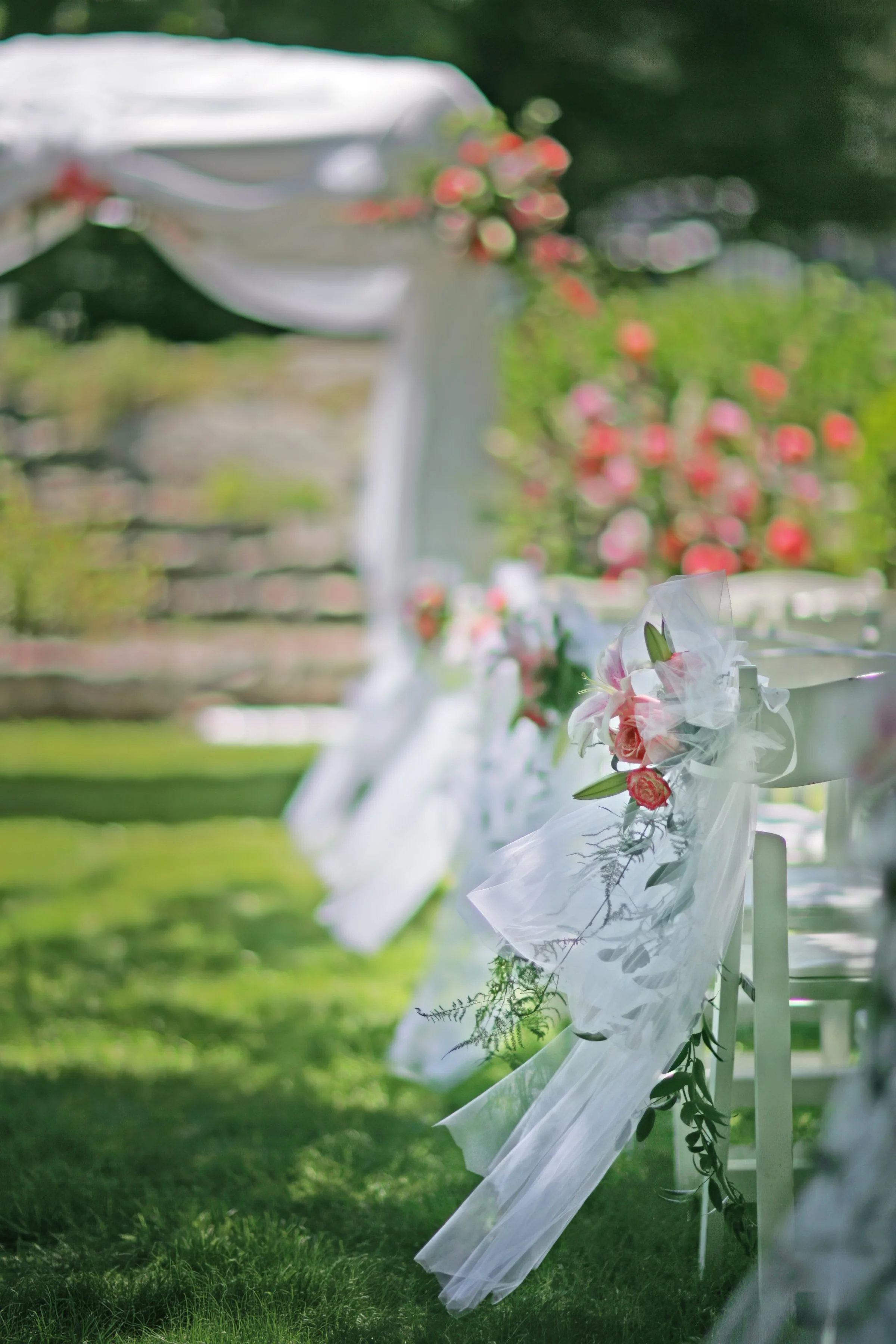 Wedding ceremony decor moving in gentle breeze at Spa at Norwich Inn outdoor garden venue