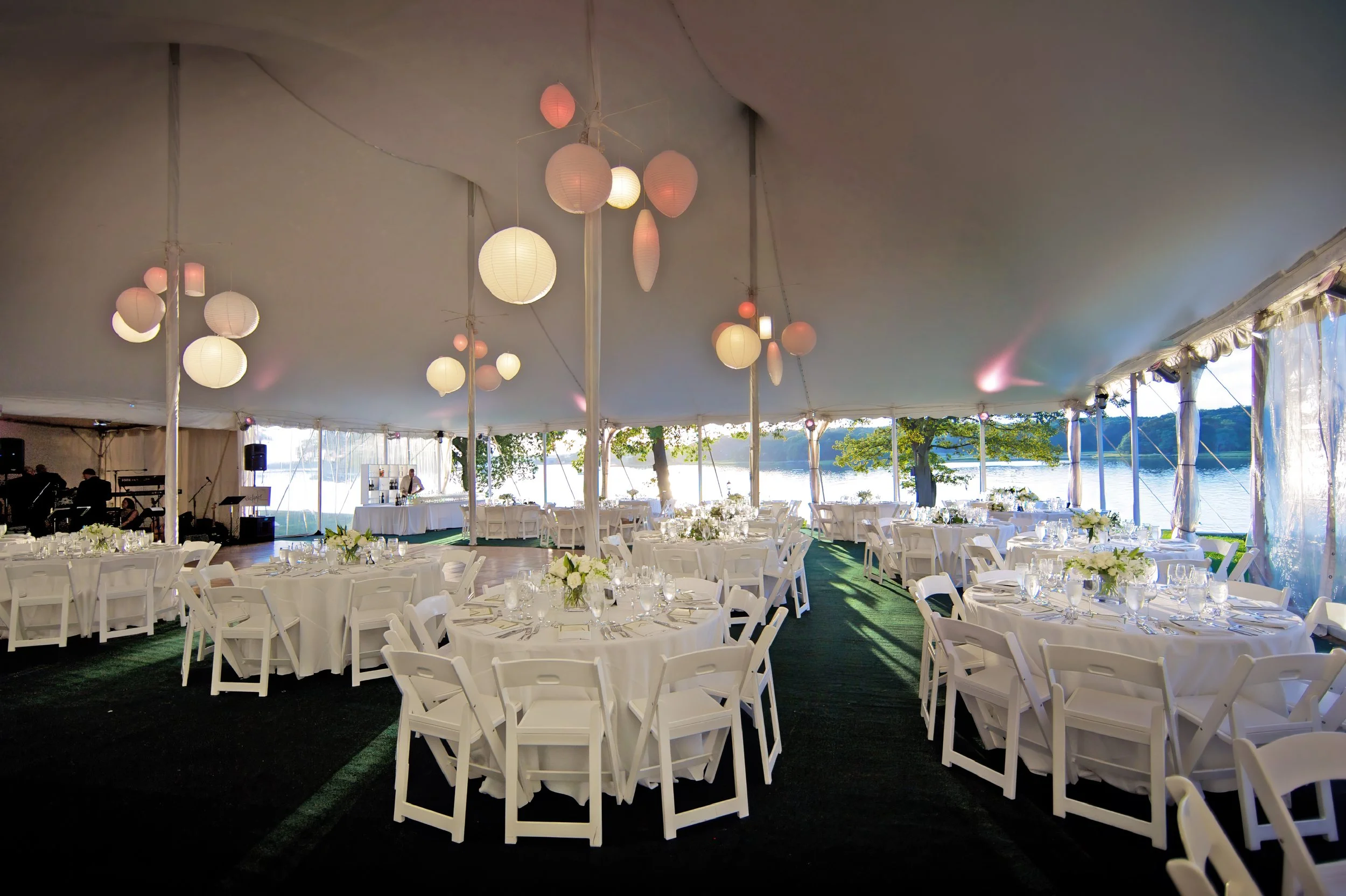 Wainwright House glows under the night sky, highlighting its elegance and waterfront setting.