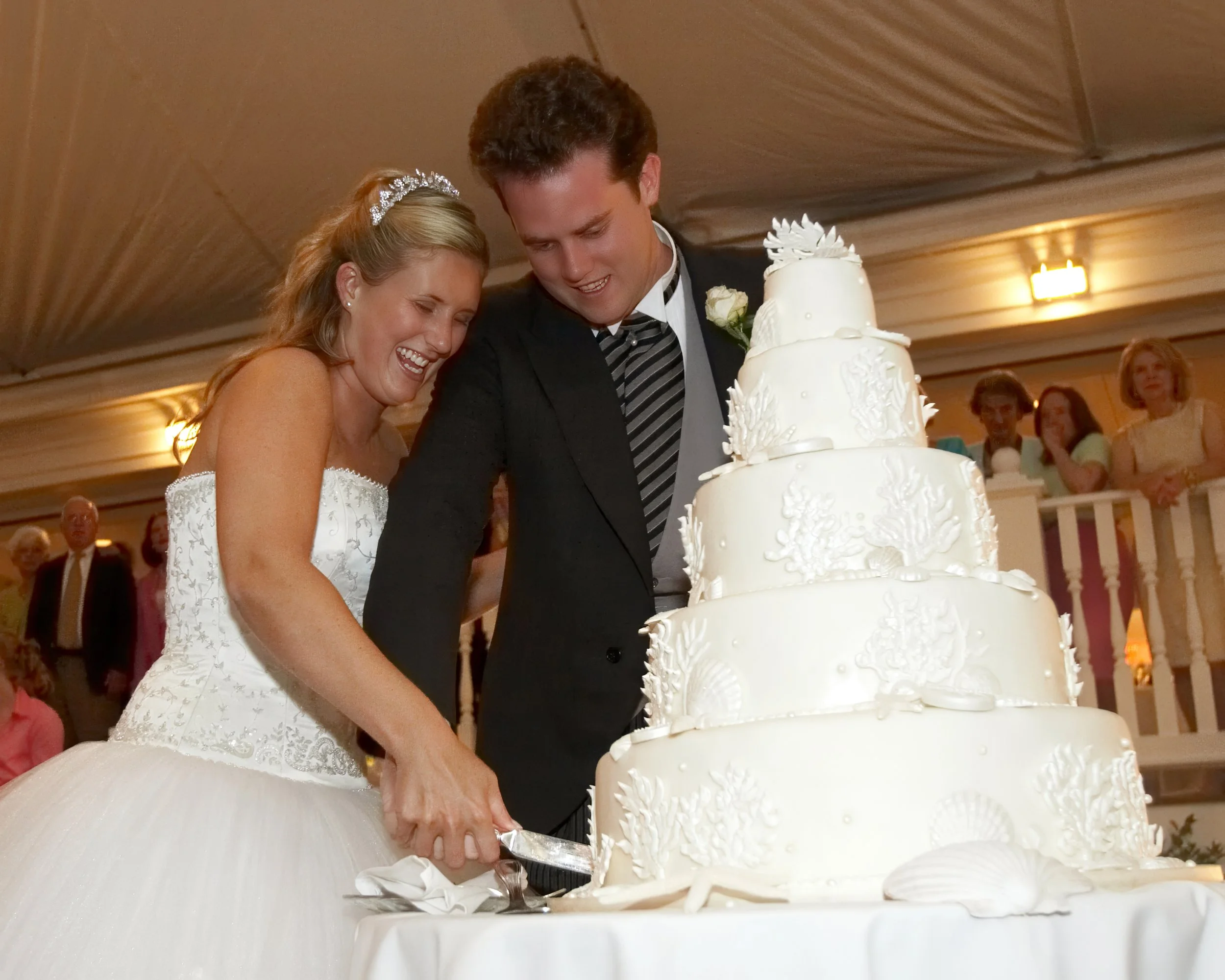 Bride and groom cut their wedding cake during the reception at Belle Haven Yacht Club.