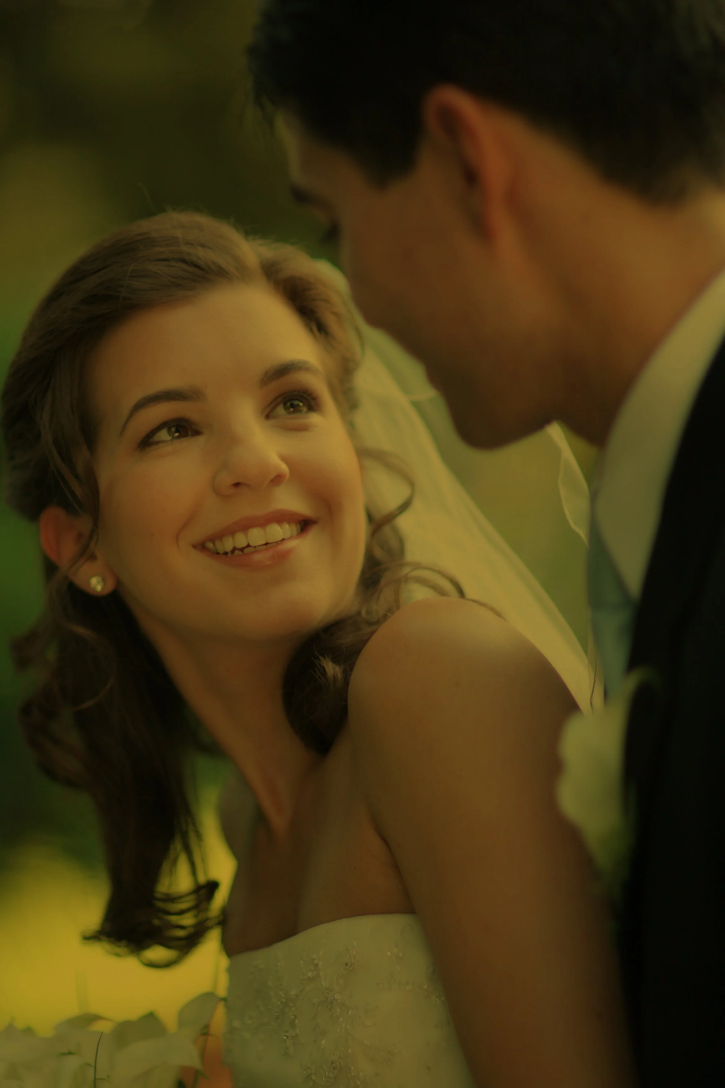 Bride and groom share an intimate moment on the wooded paths at Tappan Hill, surrounded by lush greenery.