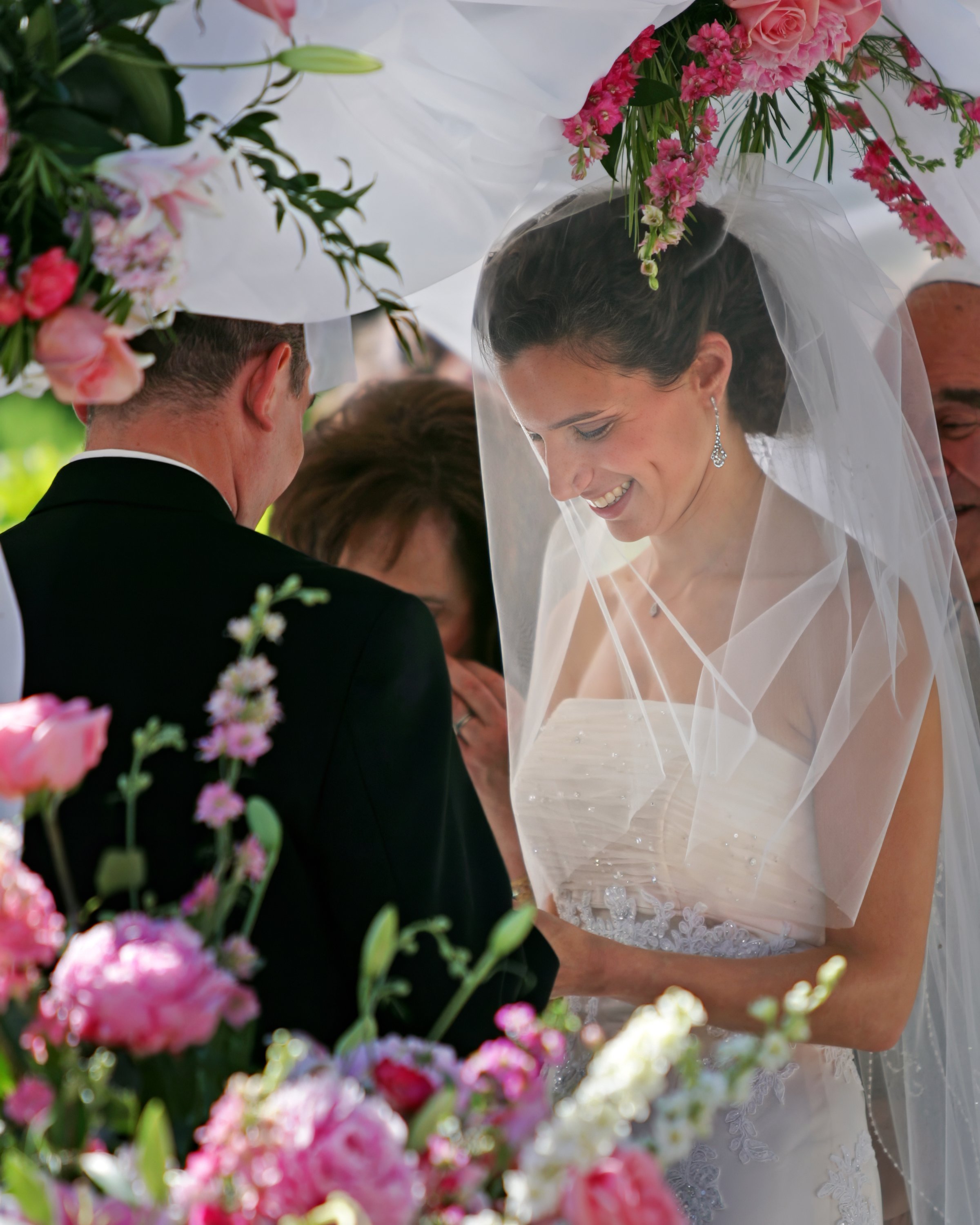 Bride and groom exchanging vows during an outdoor ceremony at The Spa at Norwich Inn in Connecticut.