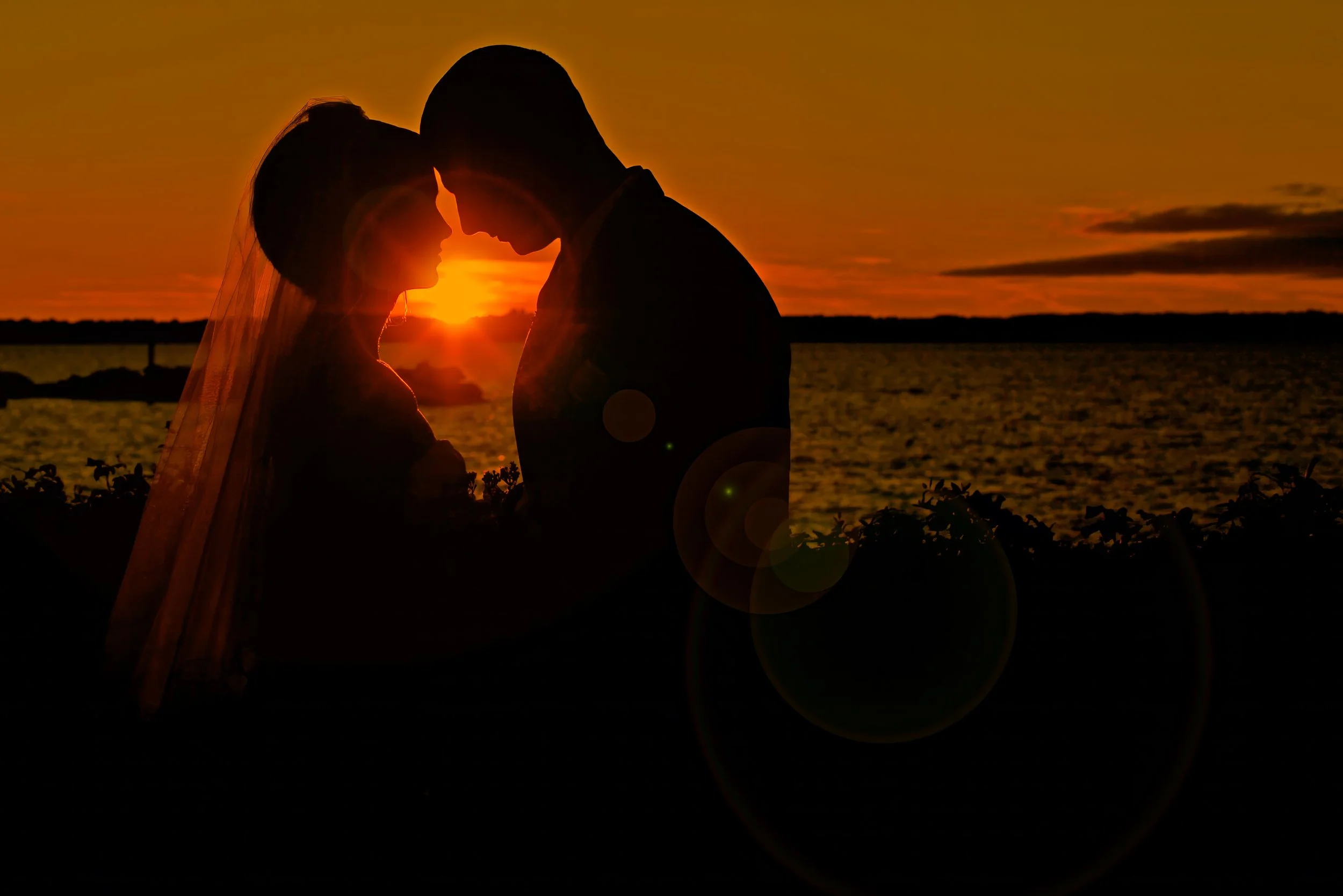 Bride and groom at sunset on the Connecticut shoreline during wedding at Amarante’s Sea Cliff in New Haven