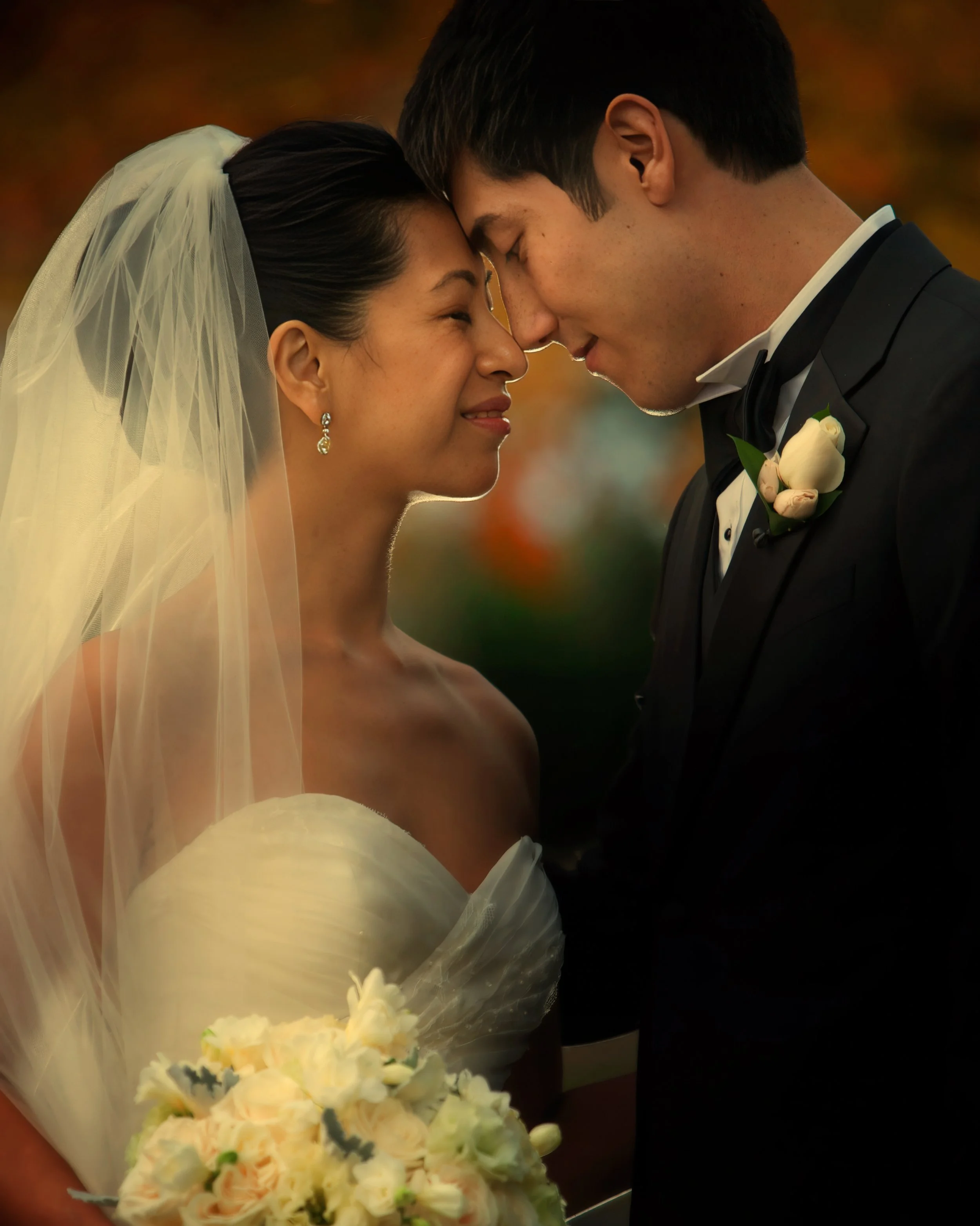 Bride and groom pose for a classic portrait in the fall at Glen Island Harbour Club