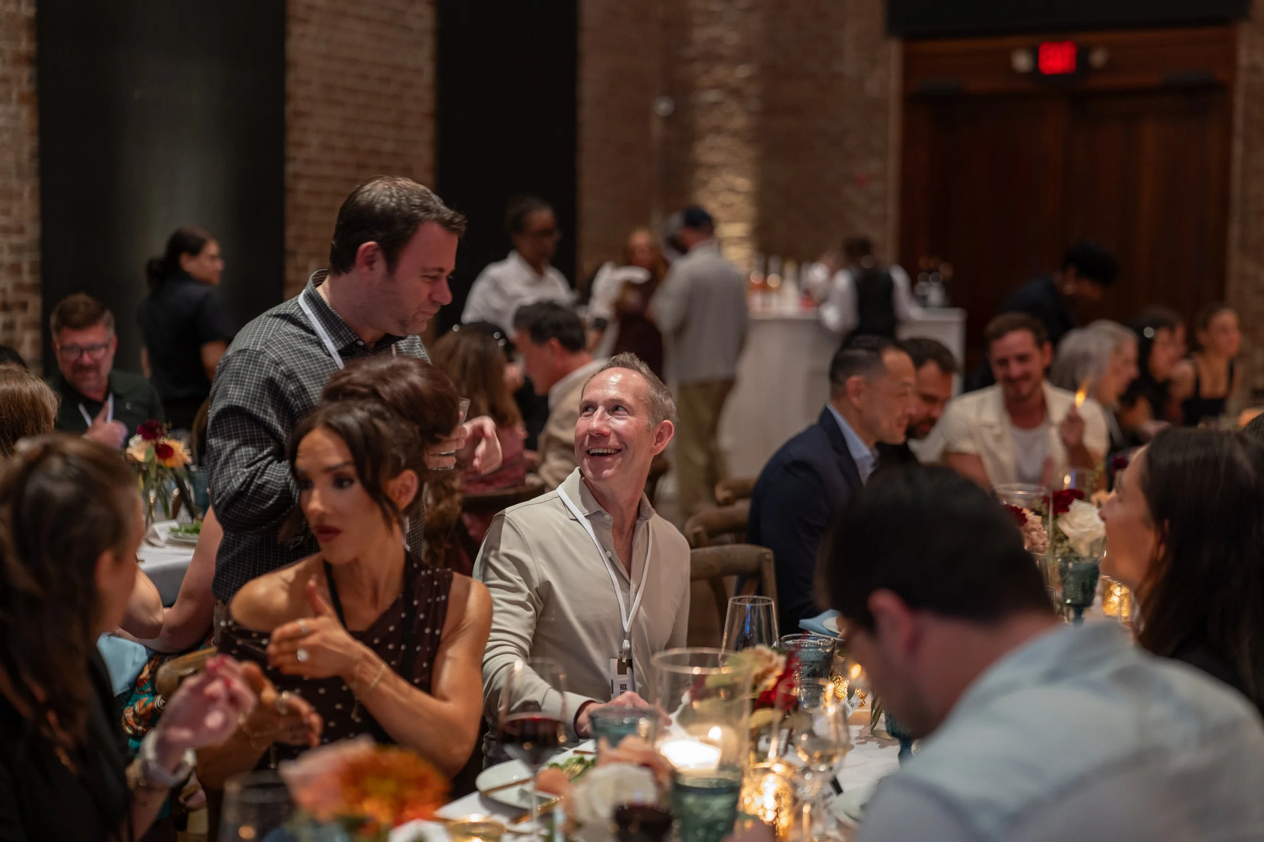 Attendees enjoying dinner and conversation at the Stay and Gather corporate event.