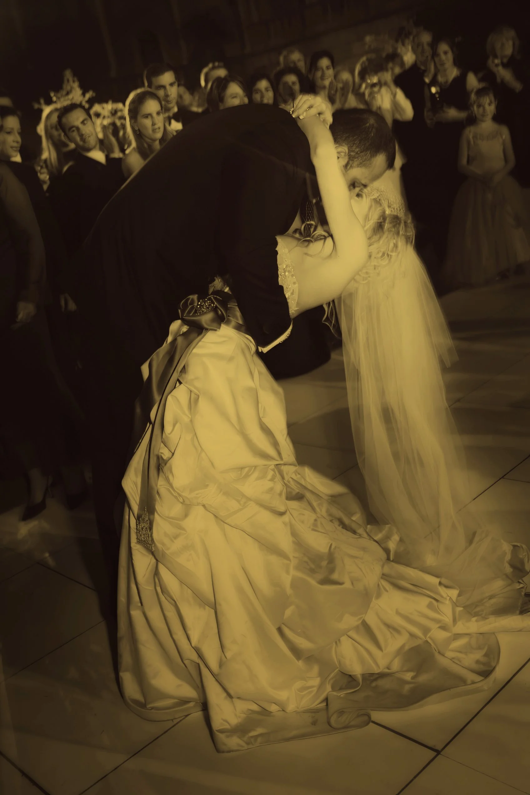 Groom dips the bride for a kiss at the end of their first dance at The Ringling Museum in Sarasota.