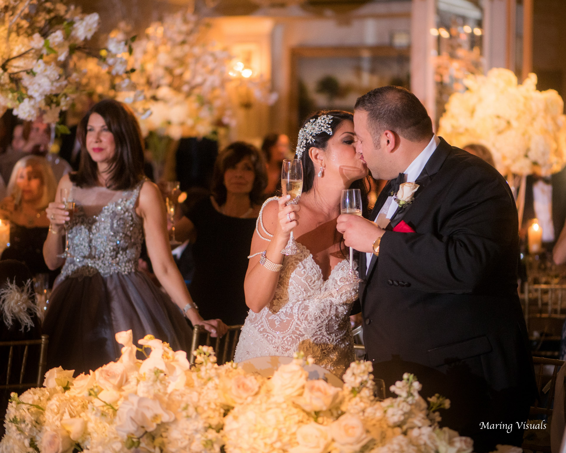 Bride and Groom toast one another with a kiss in the Pierre Hotel Ballroom NYC
