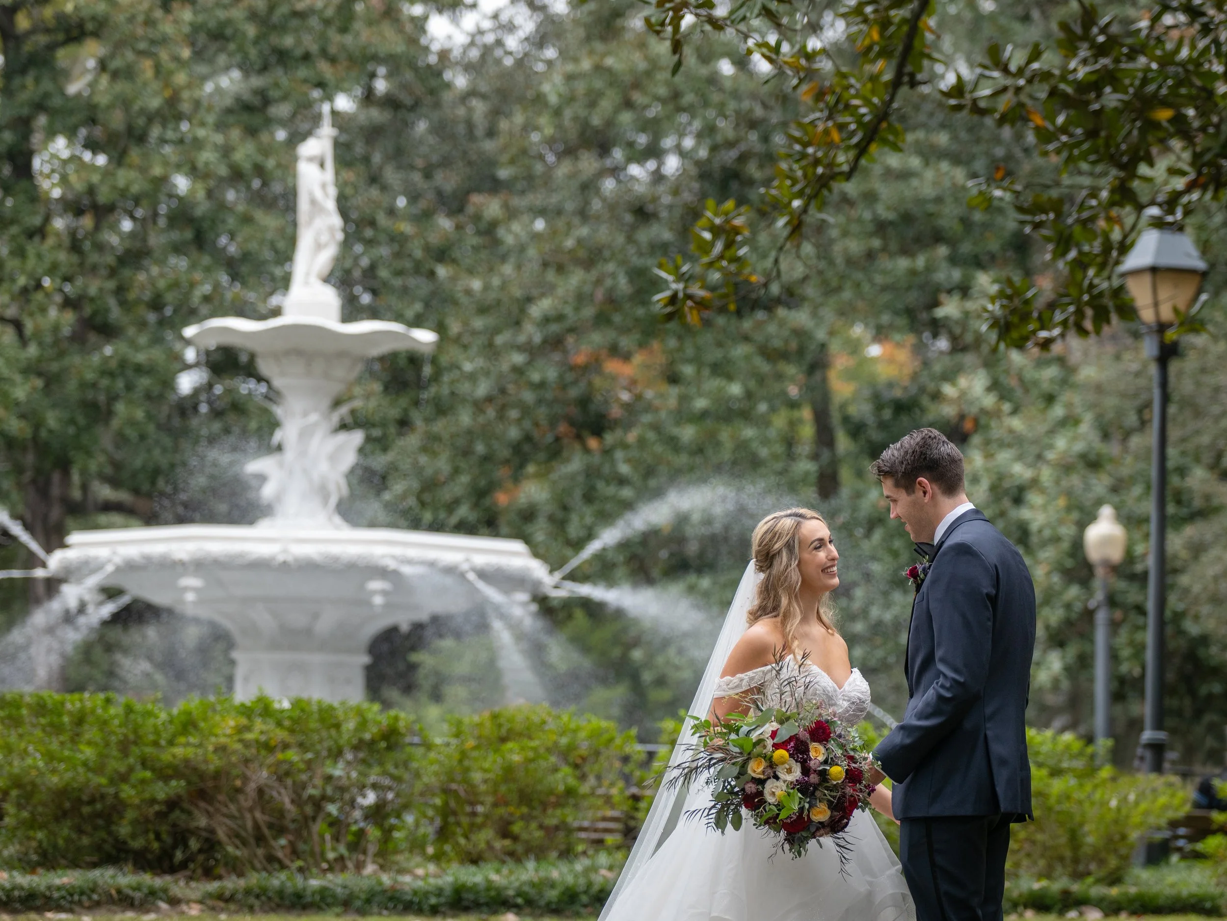 A wedding couple at the Forsyth Park Fountain